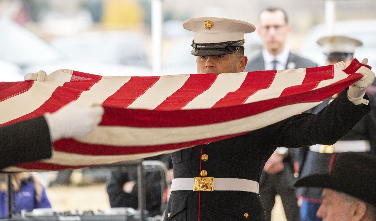 A U.S. Marine folds an American flag during memorial services for Lance Cpl. Rylee McCollum on Saturday at the Gill Ranch. McCollum was killed August 26 with 12 other U.S. service members in a suicide bombing while evacuating civilians and U.S. allies from Kabul, Afghanistan. (Bradly J. Boner, Jackson Hole News&Guide)