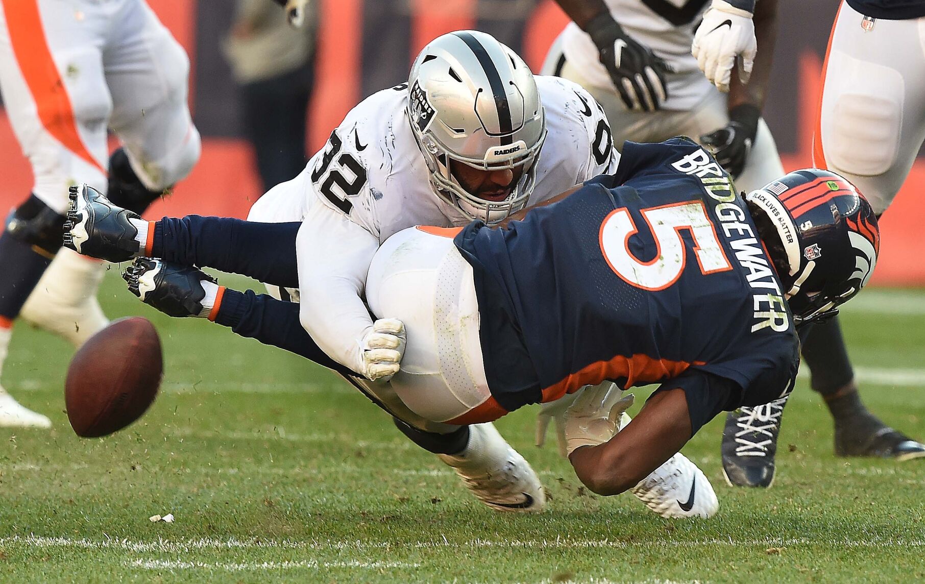 Broncos quarterback Teddy Bridgewater coughs up the ball while being tackled Raiders safety Dallin Leavitt during the fourth quarter of the game at Empower Field at Mile High Stadium on Sunday, Oct. 17, 2021. The Broncos were defeated 34-24. (Photo by Jerilee Bennett, The Gazette)