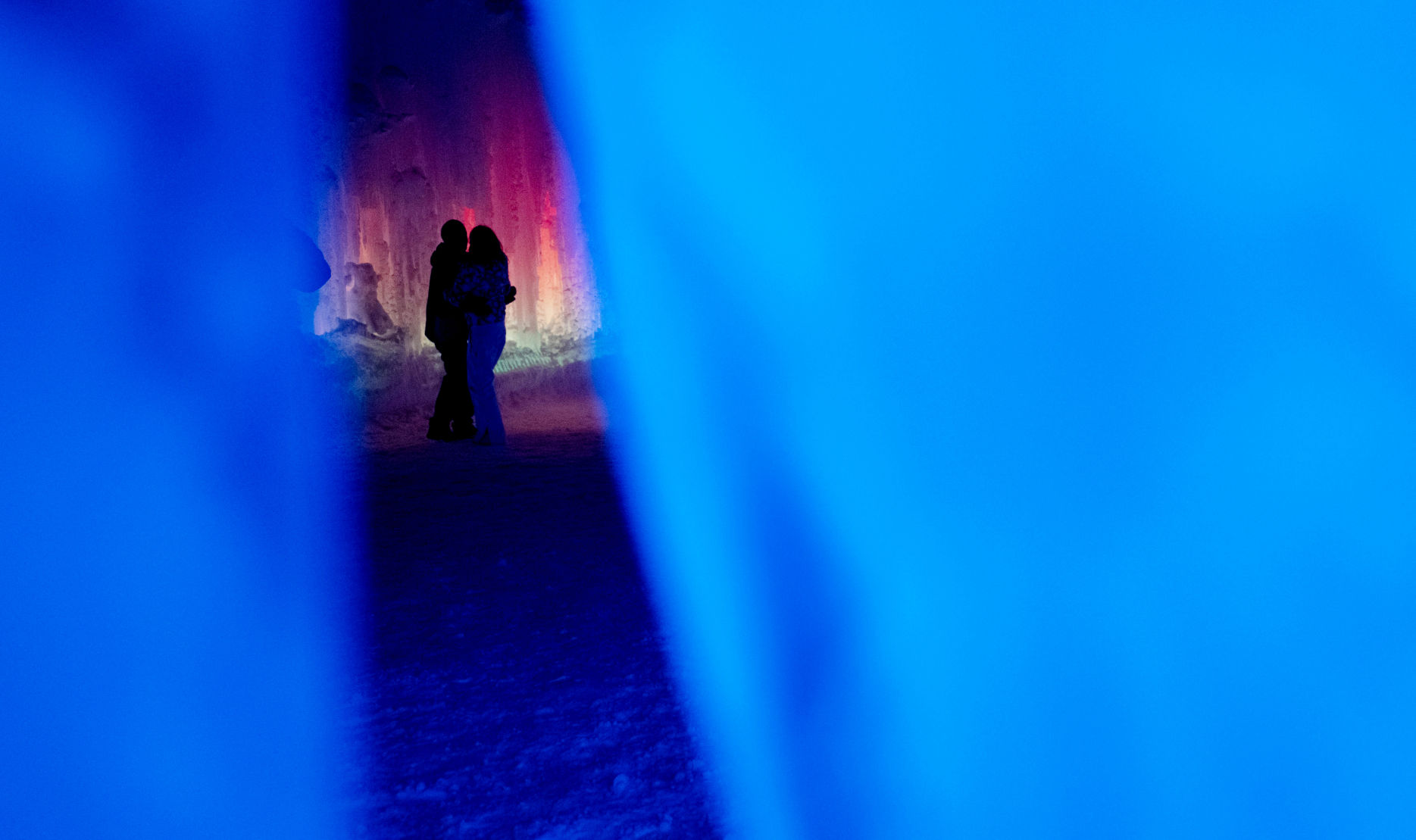 Chris Oberle and Kristen Ergenbright of Denver embrace kiss at the Ice Castles in Dillon, Colo., on Friday, Jan. 17, 2020. The handmade frozen attraction is one of six across North America. A team of professional ice artists hand-place hundreds of thousands of icicles which takes approximately two months to build and weighs more than 25 million pounds.(Chancey Bush/ The Gazette) (Chancey Bush The Gazette)