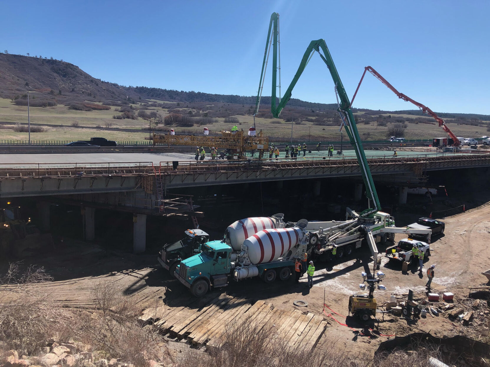 Crews lay asphalt as part of work to complete the Plum Creek bridge over Interstate 25. The bridge is one of four completed in the I-25 South Gap project, widening lanes along the 18-mile stretch of roadway between Monument and Castle Rock. The project includes five total bridges. (Courtesy of Colorado Department of Transportation)