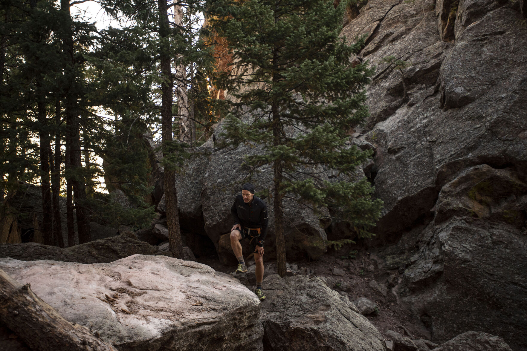 Satan’s Minions Scrambling Club founder Bill Wright makes his way through small boulders this month near the Flatirons of Boulder. (Chancey Bush,The Denver Gazette)
