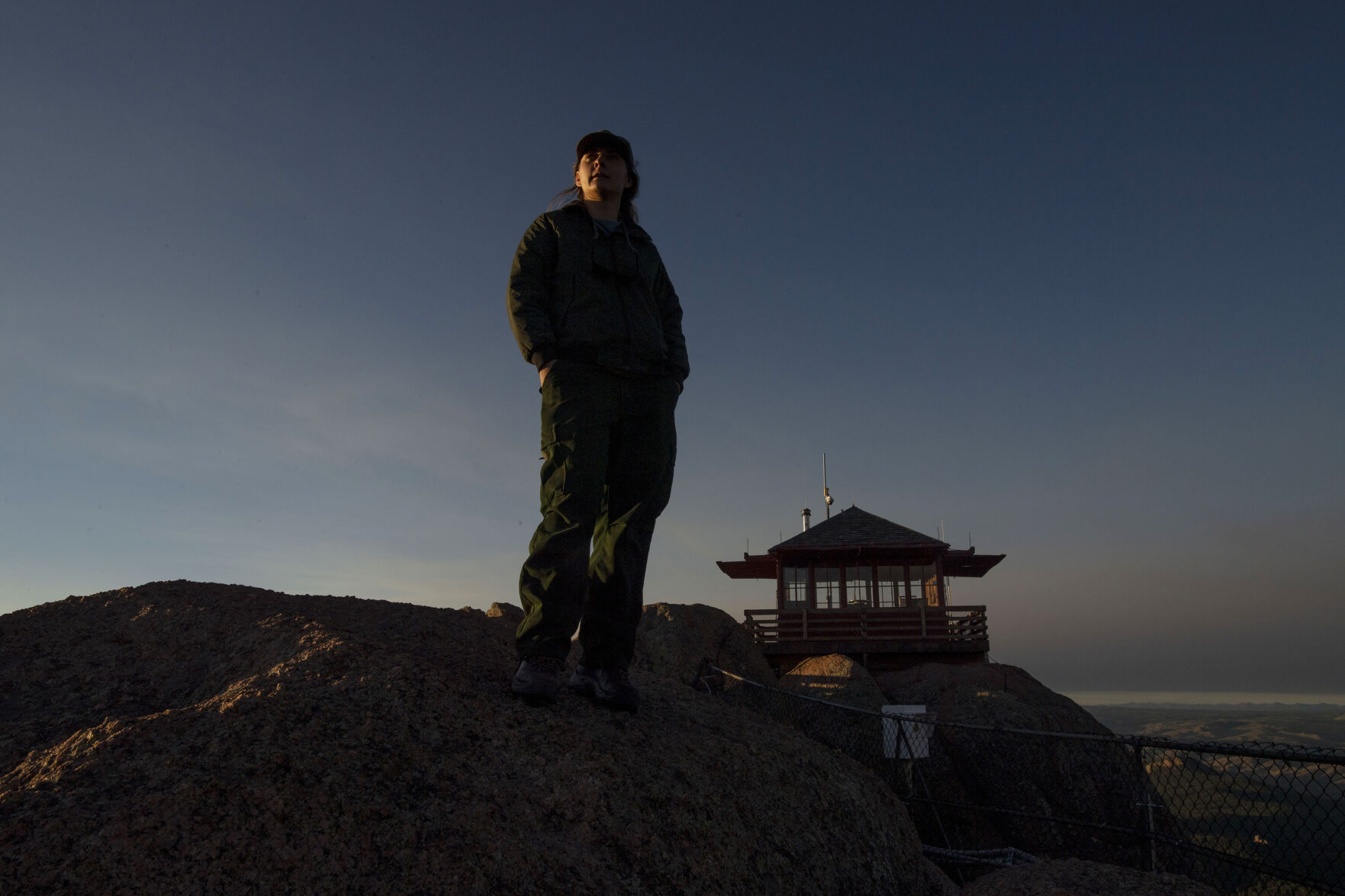 Ashley Farinacci-Silfies stands near the Devil’s Head Fire Lookout Tower. From the tower at nearly 10,000 feet, there’s a panoramic view of hundreds of miles of mountains and clouds and trees and rocks. (photos by Chancey Bush, The Gazette)