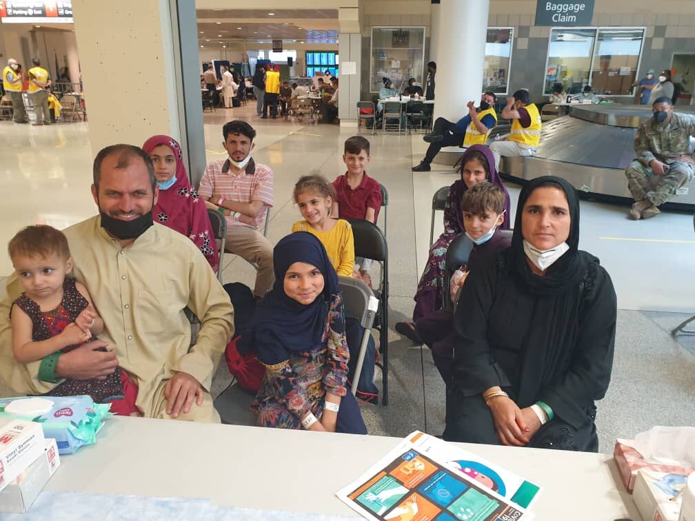 An Afghan family of ten who had just fled from Kabul airport waits in Hkia airport for a flight to Germany. (Chris Liggett)