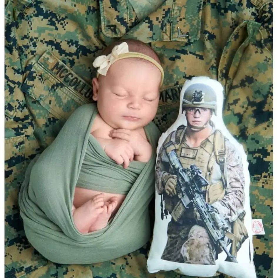 Levi Rylee Rose is bundled in her father's Marine T-shirt next to a photo of him fashioned into a pillow. (Jim McCollum)