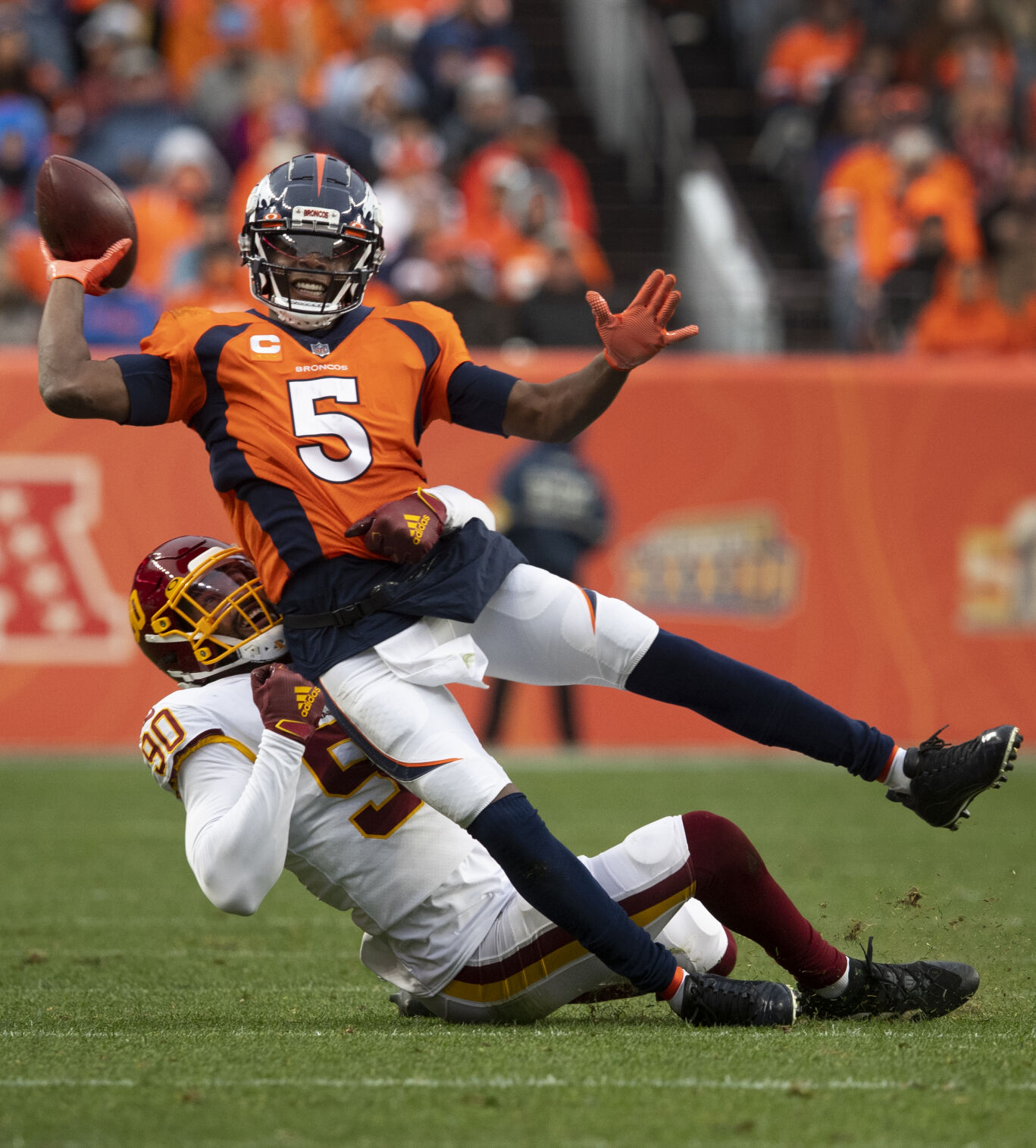 Denver Broncos quarterback Teddy Bridgewater (5) throws down field as Washington Football Team defensive end Montez Sweat (90) brings him to the ground during the fourth quarter Sunday, Oct. 31, 2021, at Empower Field at Mile High in Denver. Denver won 17-10.(The Gazette, Christian Murdock) (Christian Murdock/The Gazette)