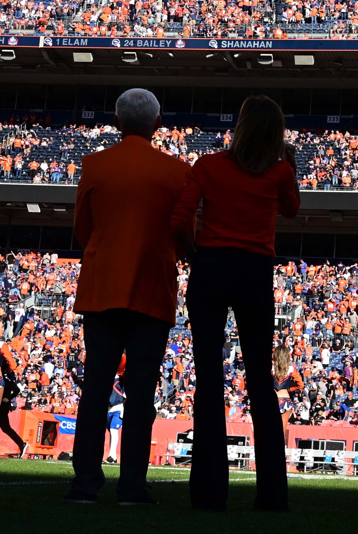 Mike Shanahan and his wife, Peggy Shanahan, look up to see his name in the Ring of Fame during a halftime ceremony. (Photo by Jerilee Bennett, The Gazette)