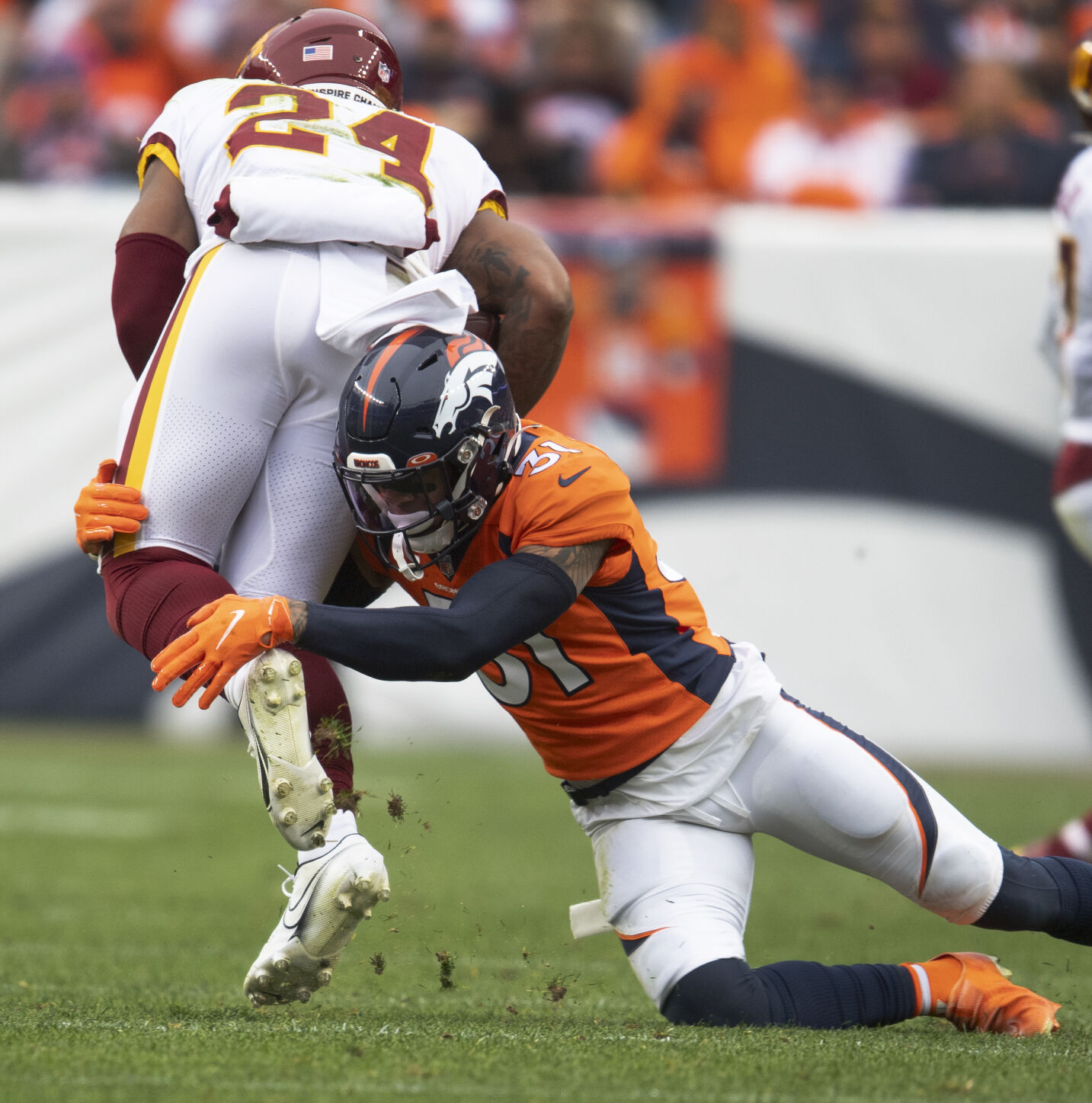 Denver Broncos free safety Justin Simmons (31) tackles Washington Football Team running back Antonio Gibson (24) during the second quarter Sunday, Oct. 31, 2021, at Empower Field at Mile High in Denver. (The Gazette, Christian Murdock) (Christian Murdock/The Gazette)