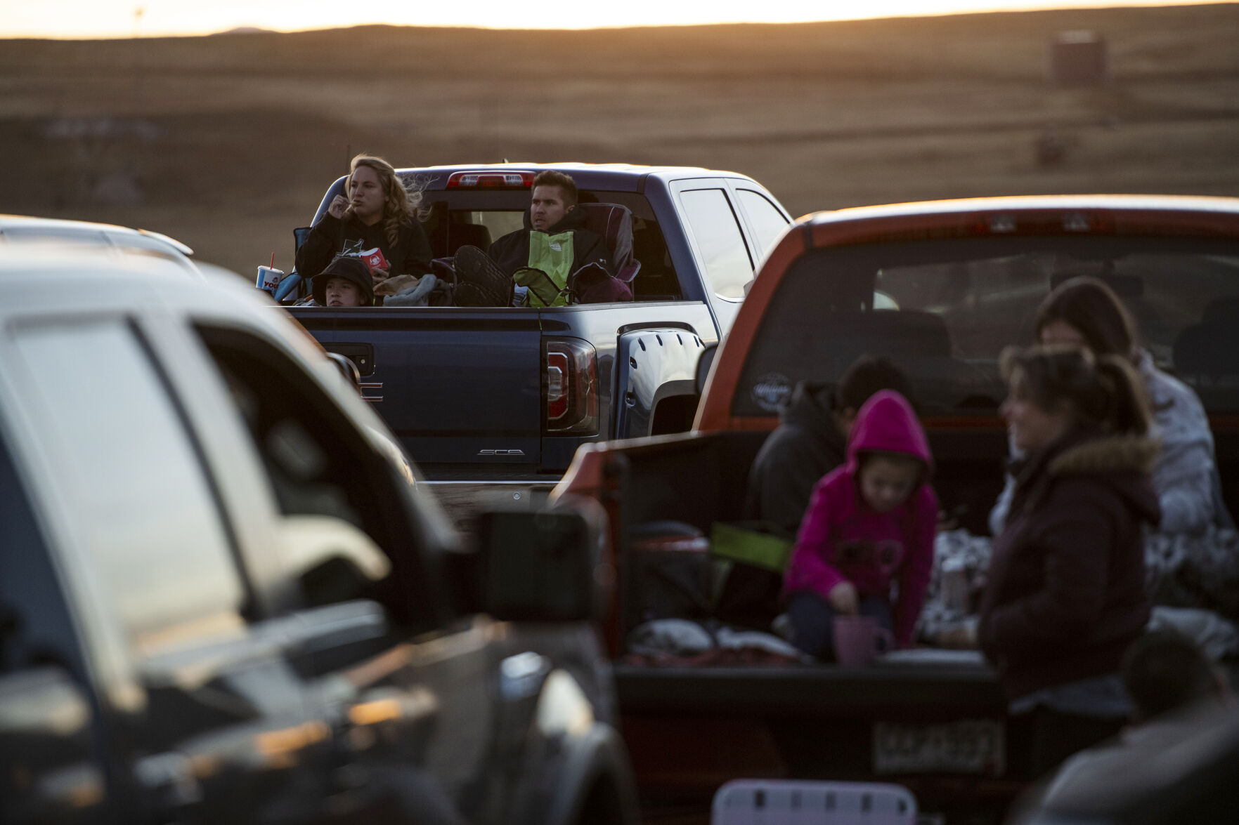 People tailgate before the start of the Cabin Fever Laser Show at the El Paso County Fairgrounds in Calhan, Colo., on Friday, Oct. 22, 2021. The drive-in laser light show was started during the COVID-19 pandemic, offering a unique socially distance entertainment experience. The show includes 25 high-powered lasers and DUAL large screen Laser projection. The last show is Sunday at 7:30pm. (Chancey Bush / The Gazette) (Chancey Bush/ The Gazette)