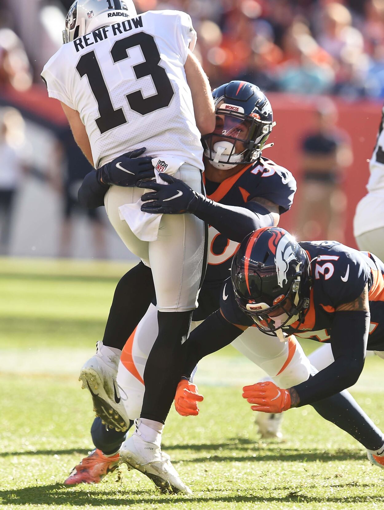 Broncos safety Justin Simmons and safety Caden Sterns try to stop Raiders wide receiver Hunter Renfrow. The Broncos lost to the Raiders 34-24 on Sunday, Oct. 17, 2021 at Empower Field at Mile High Stadium. (Photo by Jerilee Bennett, The Gazette) (Jerilee Bennett)