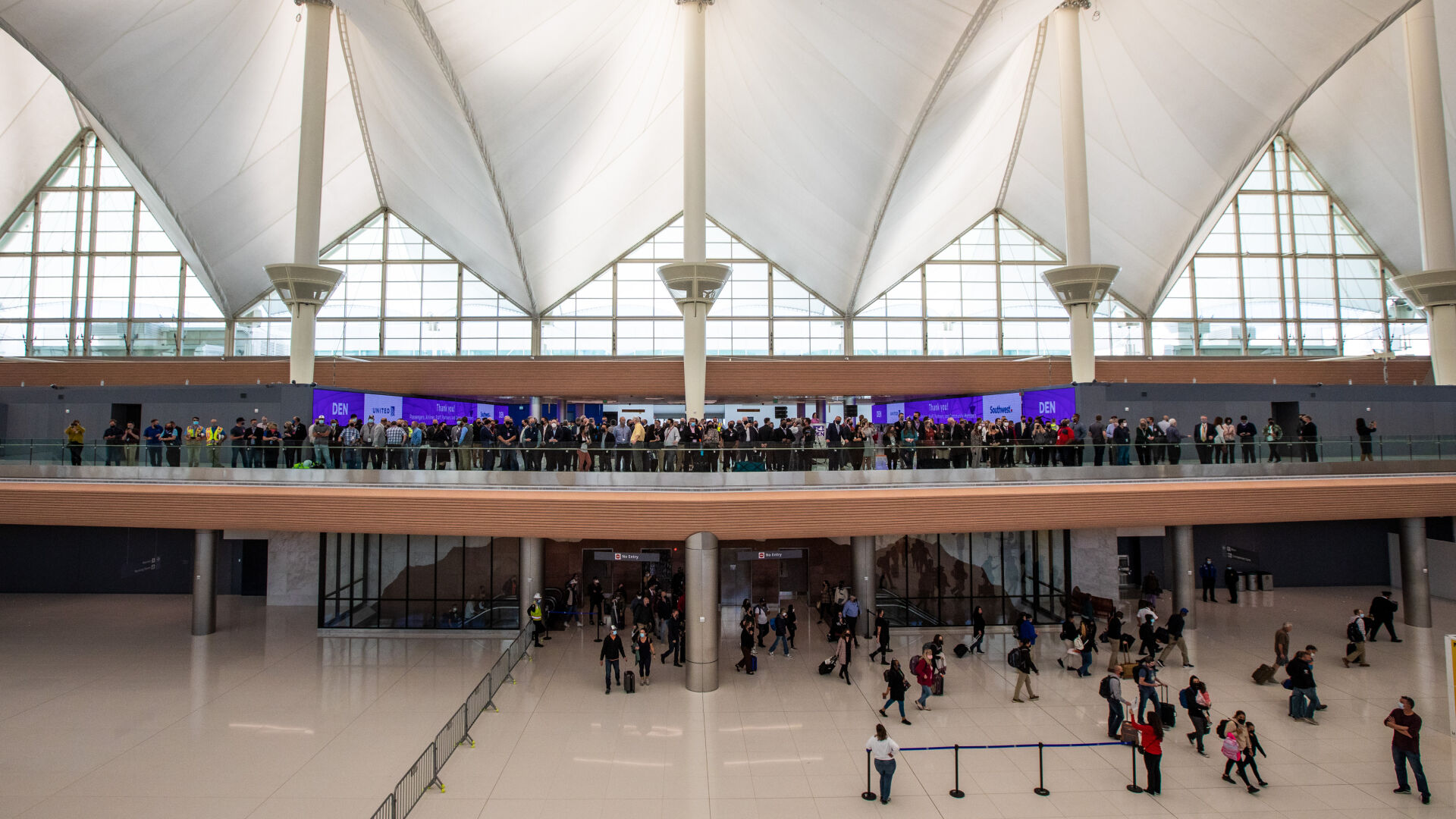 Officials and media represenatives on level 6, prepared for the ribbon cutting to mark the completion of phase one of the Great Hall improvements. The improvements added 86 check-in stations for United and Southwest airlines. (Courtesy of DIA, Peter Scott Barta)