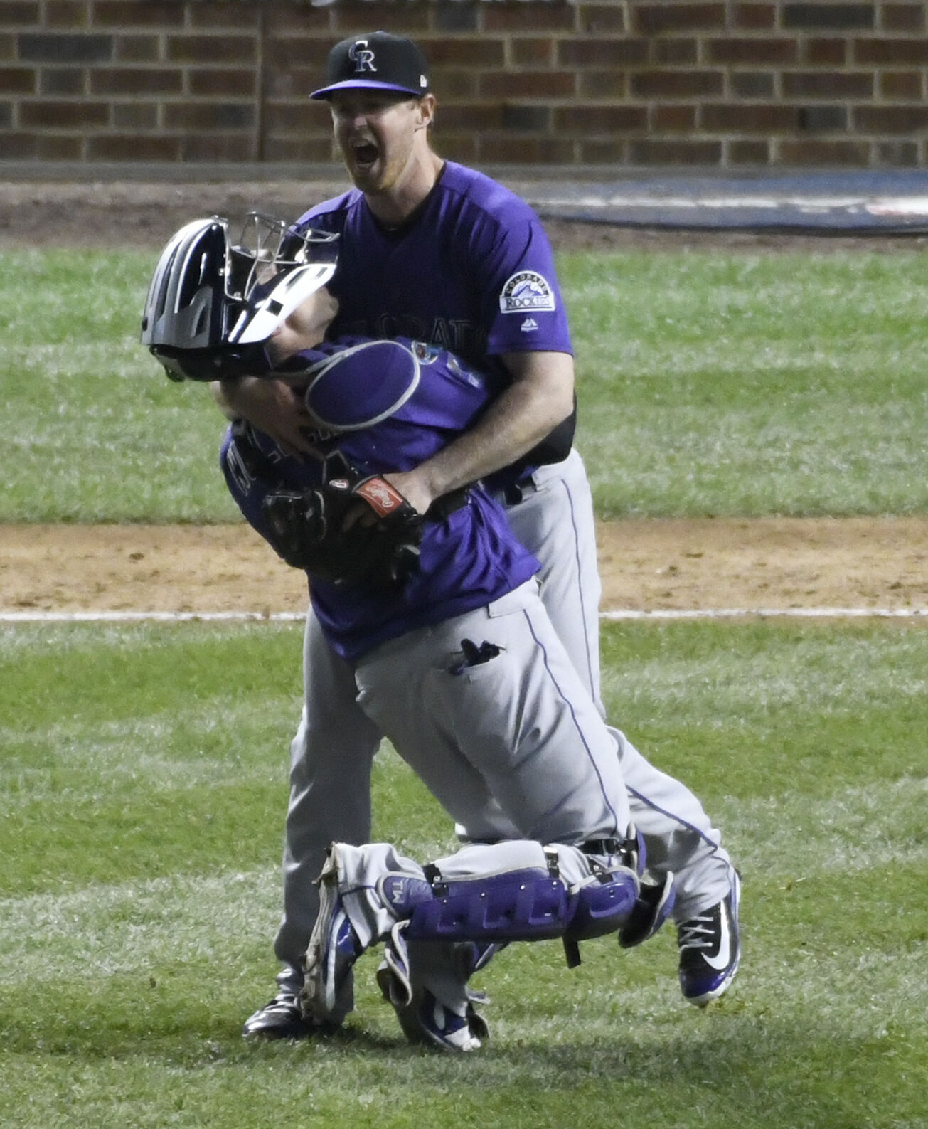 Rockies catcher Tony Wolters, front, and relief pitcher Scott Oberg celebrate their win in a wild-card playoff game Oct. 3, 2018, in Chicago. (The Associated Press file)