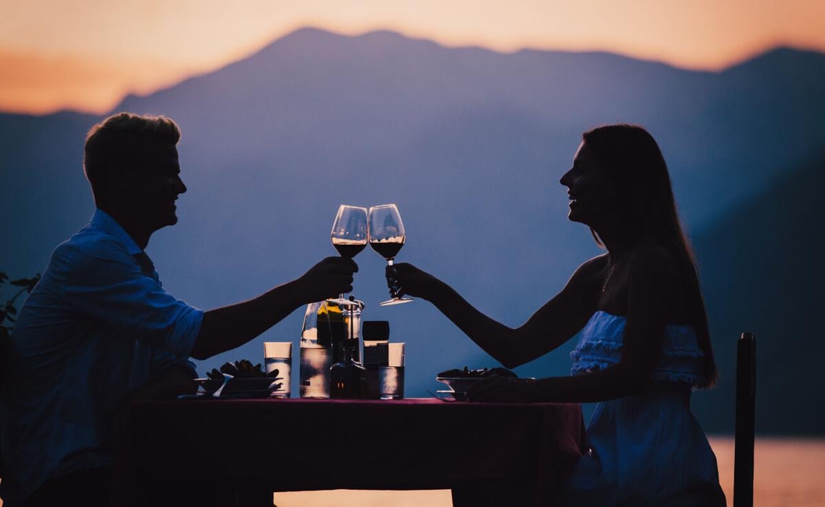Happy couple on summer evening having romantic dinner outdoor Photo Credit: nd3000 (iStock).
