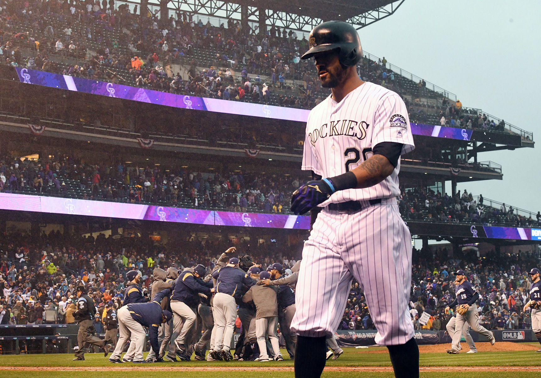 Colorado Rockies Ian Desmond walks off the field as the Milwaukee Brewers celebrate winning game 3 of the NLDS at Coors Field on Sunday, October 7, 2018. (Photo by Jerilee Bennett, The Gazette)
