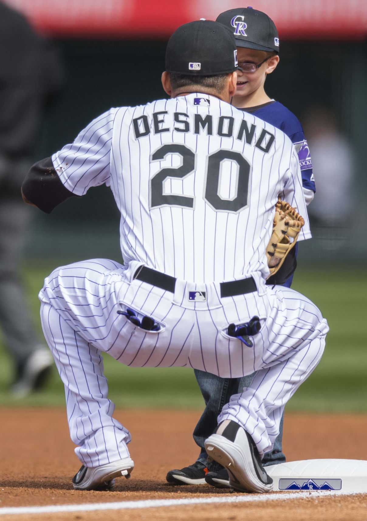Rockies first baseman Ian Desmond visits with his junior Rockies player before the start of the Rockies game against Washington Sunday, Sept. 30, 2018, at Coors Field in Denver. (The Gazette, Christian Murdock) (CHRISTIAN MURDOCK THE GAZETTE)