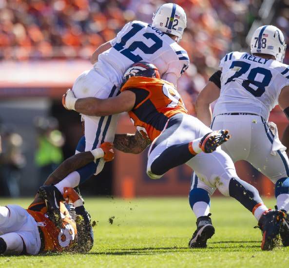 Broncos defensive linebacker Von Miller, bottom, and defensive end Derek Wolfe sack Colts quarterback Andrew Luck forcing a fourth down Sunday, Sept. 18, 2016, during the second quarter at Sports Authority Field at Mile High in Denver. (The Gazette, Christian Murdock)