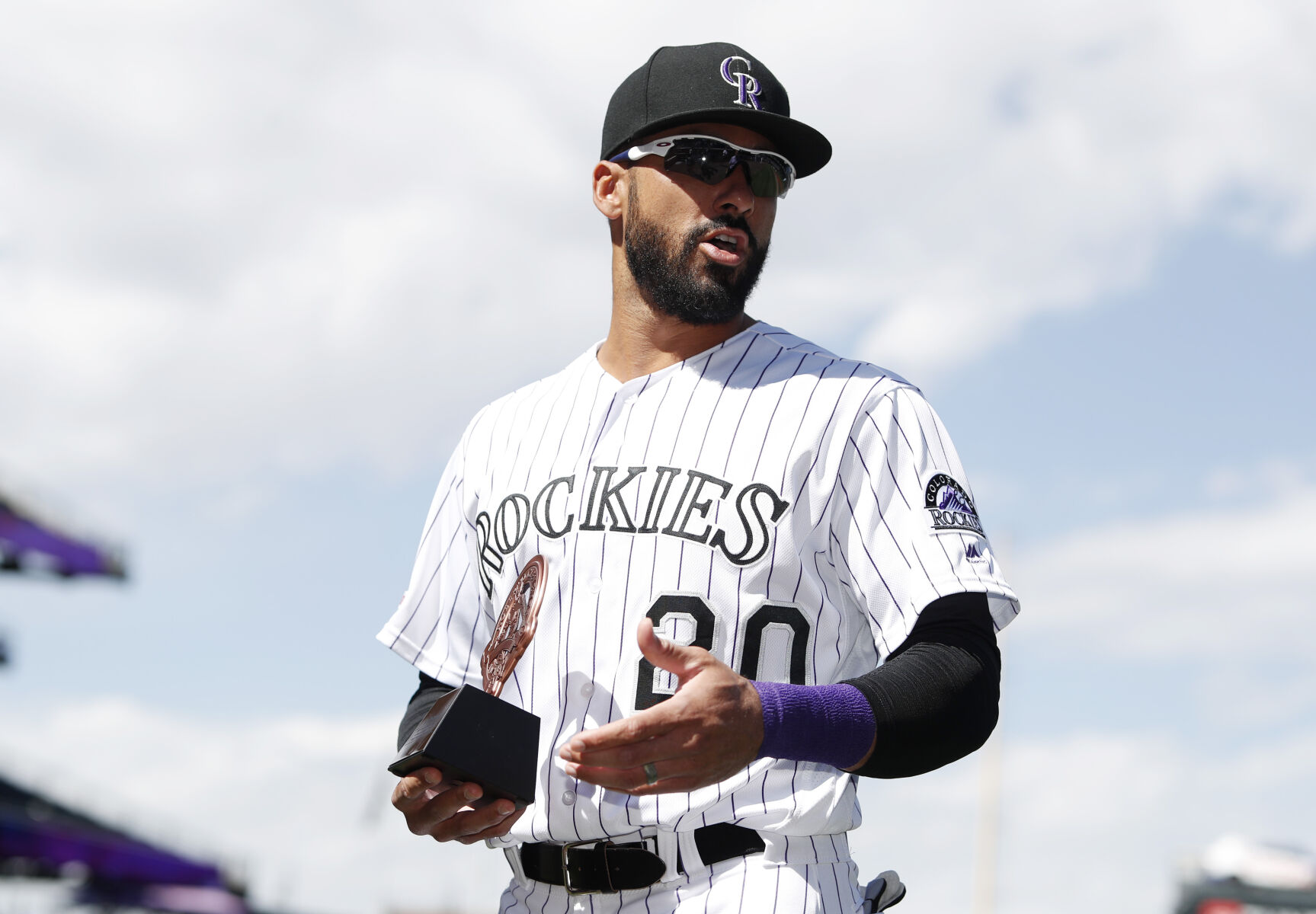 Colorado Rockies left fielder Ian Desmond holds the team's Roberto Clemente Award after it was presented to him before a baseball game against the New York Mets, Wednesday, Sept. 18, 2019, in Denver. (AP Photo/David Zalubowski) (David Zalubowski)