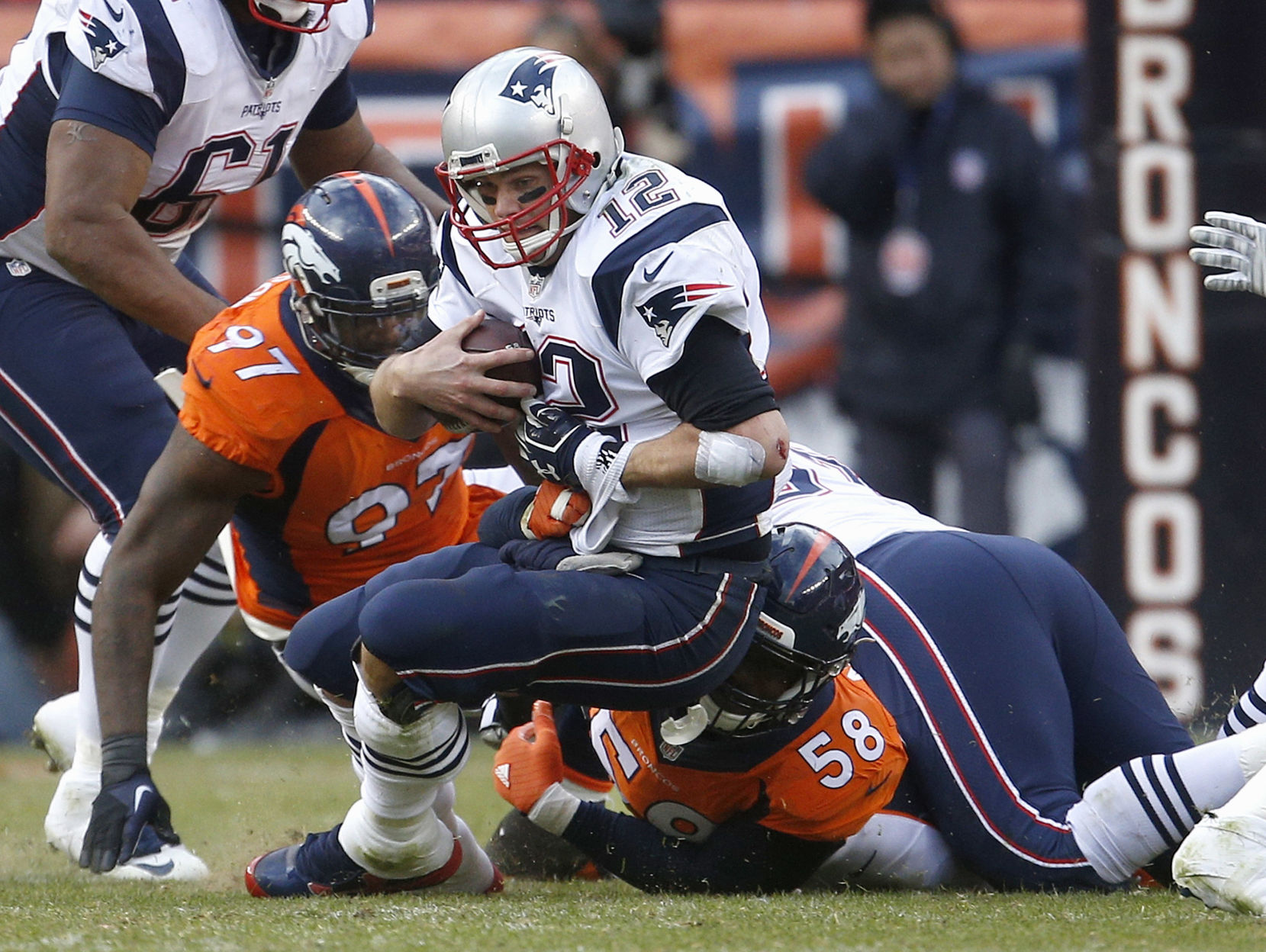 New England Patriots quarterback Tom Brady is sacked by Denver Broncos outside linebacker Von Miller (58) and Malik Jackson (97) during the second half of the NFL football AFC Championship game between the Denver Broncos and the New England Patriots, Sunday, Jan. 24, 2016, in Denver. (AP Photo/Joe Mahoney) (Joe Mahoney)