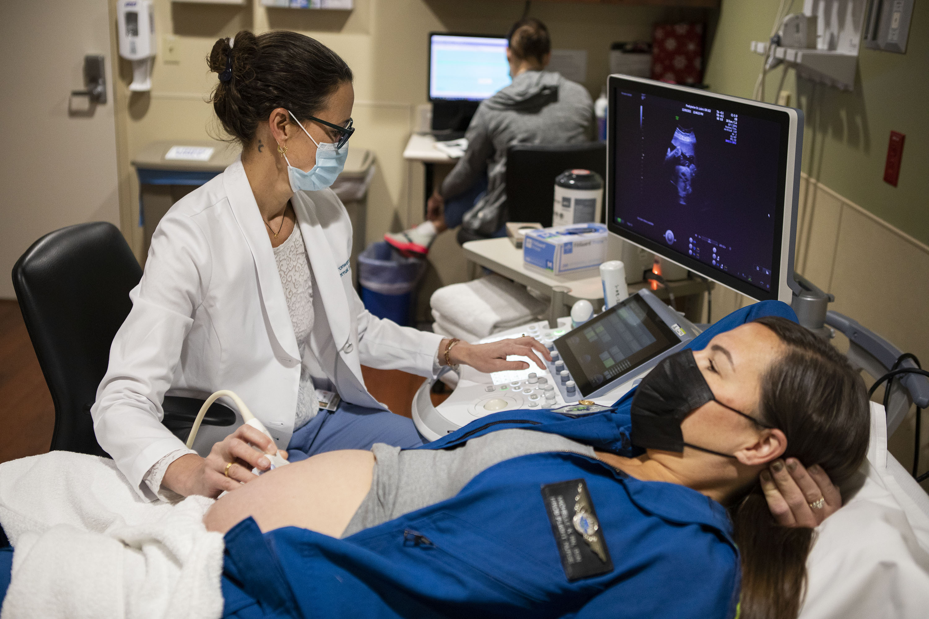 Dr. Bronwen Kahn performs an ultrasound on AirLife Denver flight nurse Michelle Krumrey, who is 30 weeks into her pregnancy, on Thursday, Dec. 9, 2021, at Presbyterian St. Luke's Medical Center in Denver, Colo. (Timothy Hurst/The Gazette) (Timothy Hurst)
