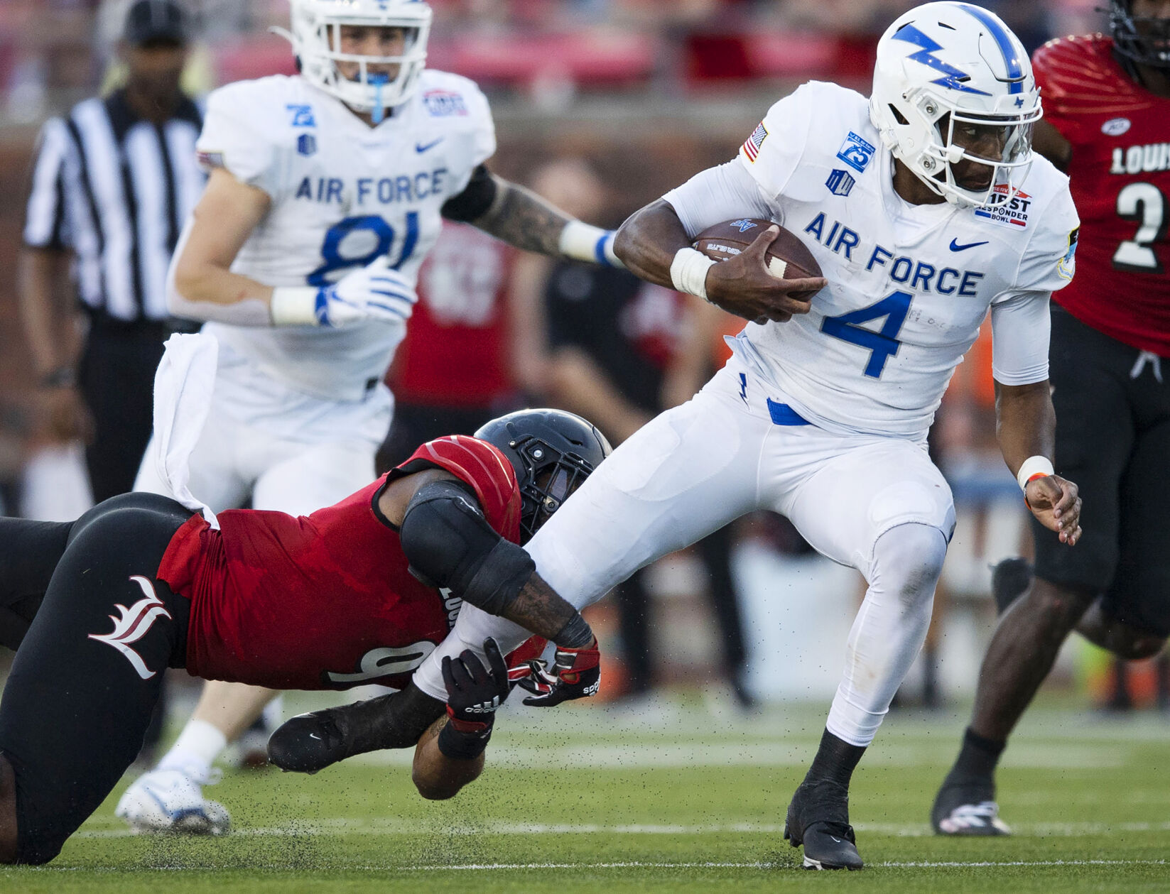 Air Force junior quarterback Haaziq Daniels (4) carries the ball as the Air Force Falcons take on the Louisville Cardinals during the 2021 First Responder Bowl at Gerald J. Ford Stadium on the campus of Southern Methodist University in Dallas, Texas on Tuesday, Dec. 28, 2021. The Falcons defeated the Cardinals and won the bowl game by a score of 31-28. (Chancey Bush/ The Gazette) (Chancey Bush/ The Gazette)
