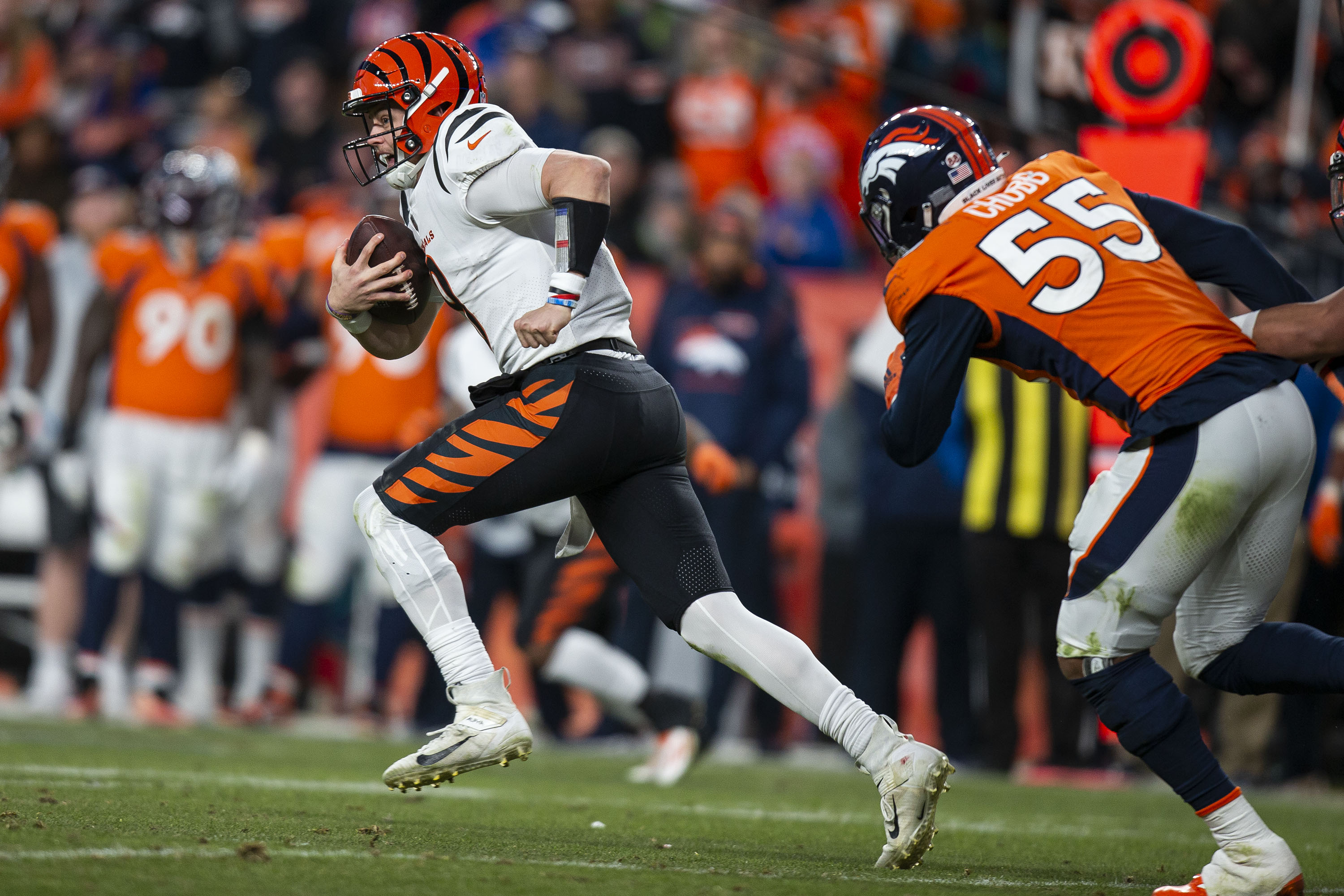 Cincinnati Bengals quarterback Joe Burrow (9) runs for a first down during a game against the Denver Broncos on Sunday, Dec. 19, 2021, at Empower Field at Mile High in Denver, Colo. (Timothy Hurst/The Gazette) (Timothy Hurst)