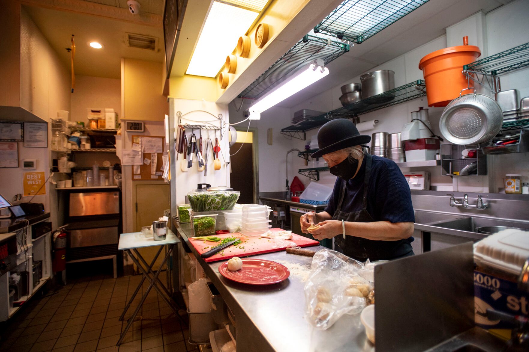 Anna Zoe, known as Ma Ma, 78, makes her special cuisine street food at her restaurant Zoe Ma Ma located on Pearl Street in Boulder in October. (Chancey Bush, The Gazette)