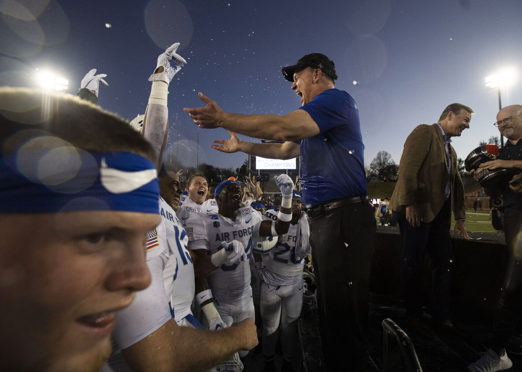 Air Force head coach Troy Calhoun celebrates with the team after the Air Force Falcons defeat the Louisville Cardinals during the 2021 First Responder Bowl at Gerald J. Ford Stadium on the campus of Southern Methodist University in Dallas, Texas on Tuesday, Dec. 28, 2021. The Falcons defeated the Cardinals and won the bowl game by a score of 31-28. (Chancey Bush/ The Gazette) (Chancey Bush/ The Gazette)