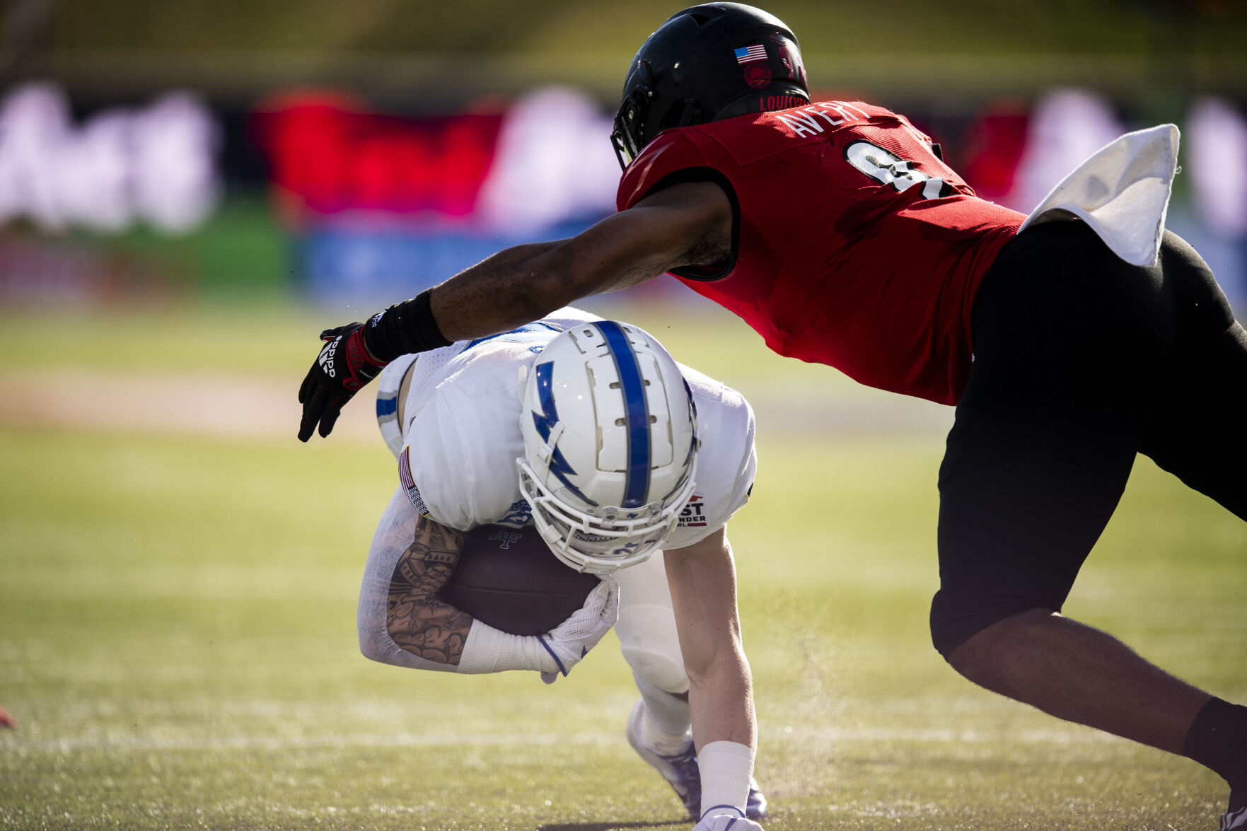 Air Force senior wide receiver Brandon Lewis (13) gets tackled as the Air Force Falcons take on the Louisville Cardinals during the 2021 First Responder Bowl at Gerald J. Ford Stadium on the campus of Southern Methodist University in Dallas, Texas on Tuesday, Dec. 28, 2021. The Falcons defeated the Cardinals and won the bowl game by a score of 31-28. (Chancey Bush/ The Gazette) (Chancey Bush/ The Gazette)