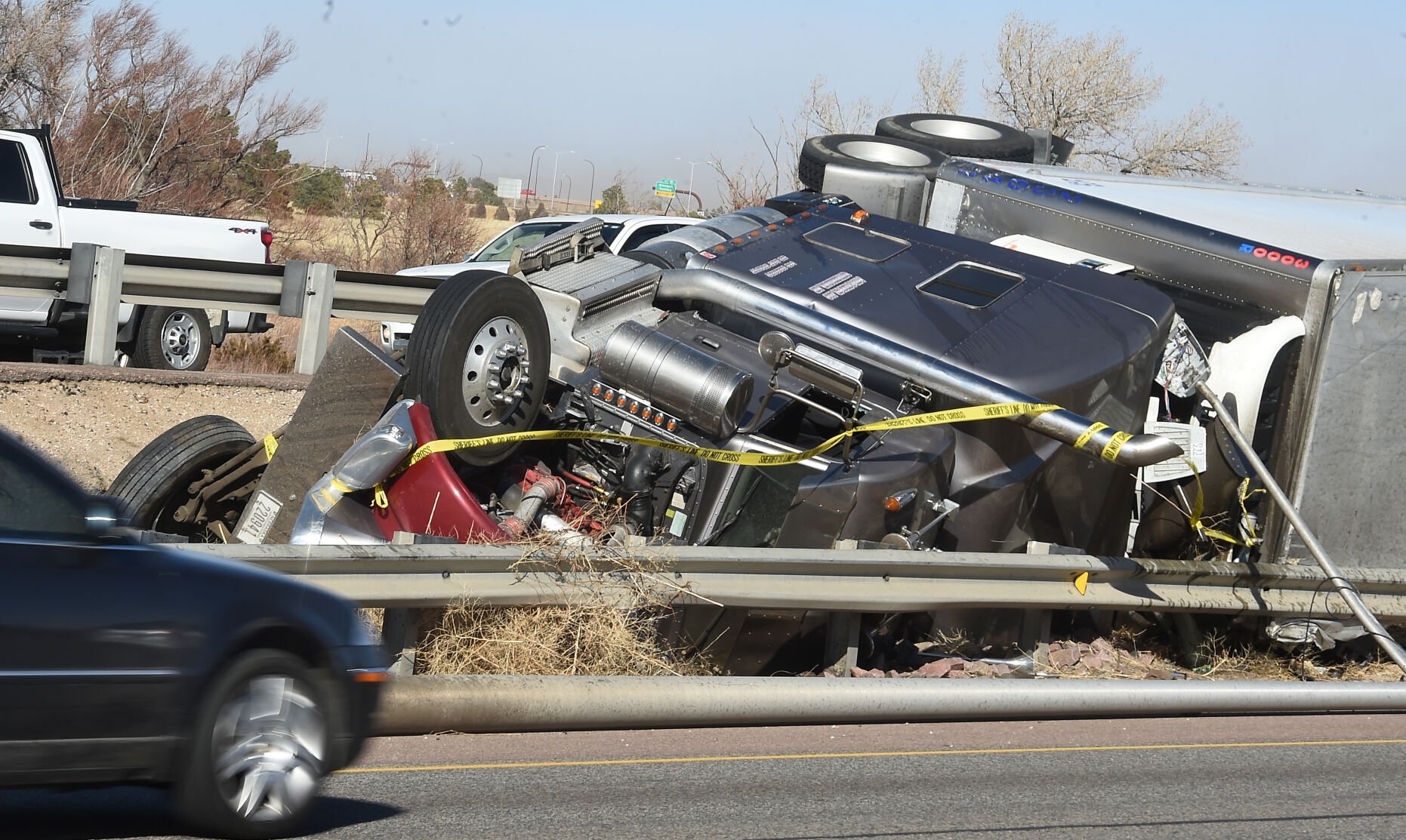 Another semi-truck in the carnage of trucks that were blown over by high winds on I-25 north of Colorado Springs.. Over a dozen semi trucks were blown over by high winds in the Pikes Peak region on I-25. (Photo by Jerilee Bennett, The Gazette) (Jerilee Bennett)