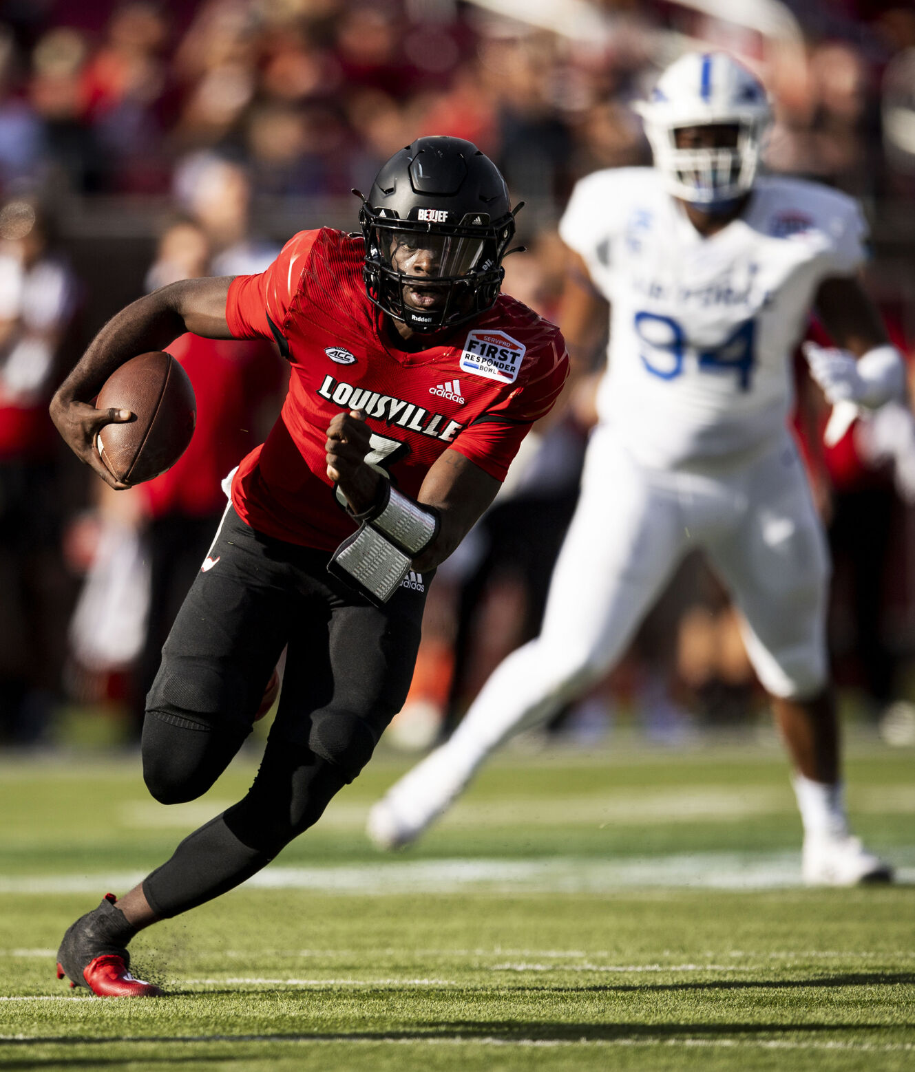 Louisville junior quarterback Malik Cunningham (3) drives the ball as the Air Force Falcons take on the Louisville Cardinals during the 2021 First Responder Bowl at Gerald J. Ford Stadium on the campus of Southern Methodist University in Dallas, Texas on Tuesday, Dec. 28, 2021. The Falcons defeated the Cardinals and won the bowl game by a score of 31-28. (Chancey Bush/ The Gazette) (Chancey Bush/ The Gazette)