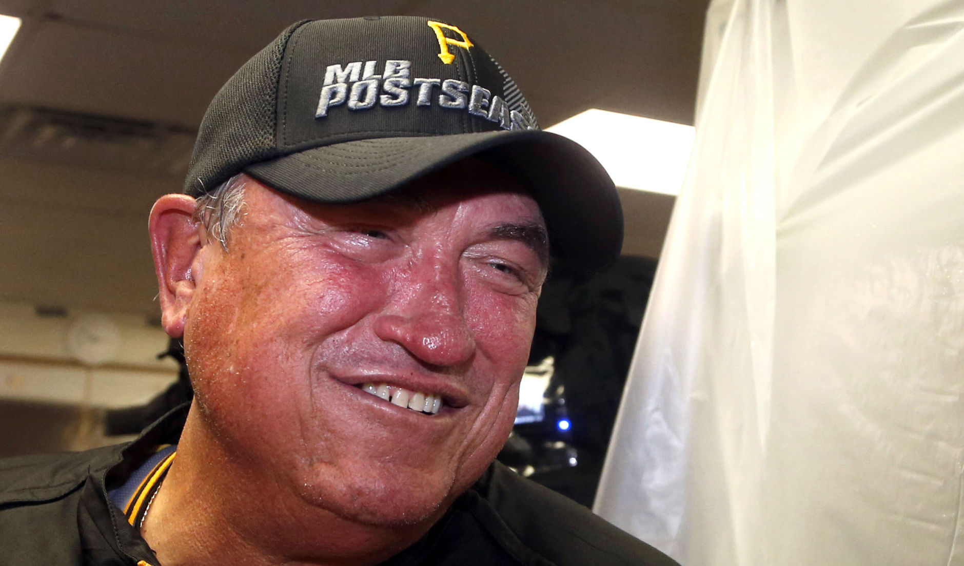 Pittsburgh Pirates manager Clint Hurdle smiles as he talks with reports and celebrates clinching a post season berth after a baseball game and 2-1 win over the Chicago Cubs Monday, Sept. 23, 2013, in Chicago. (AP Photo/Charles Rex Arbogast) (Charles Rex Arbogast)
