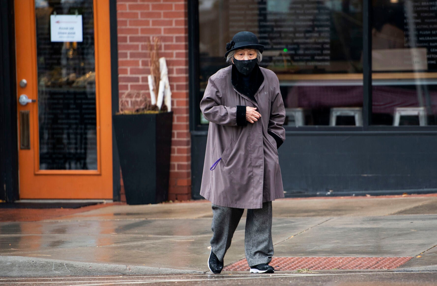 Anna Zoe, who is known as Ma Ma, 78, walks across Peal Street after dropping off food to the business across from her restaurant Zoe Ma Ma in Boulder in October. (Chancey Bush, The Gazette)