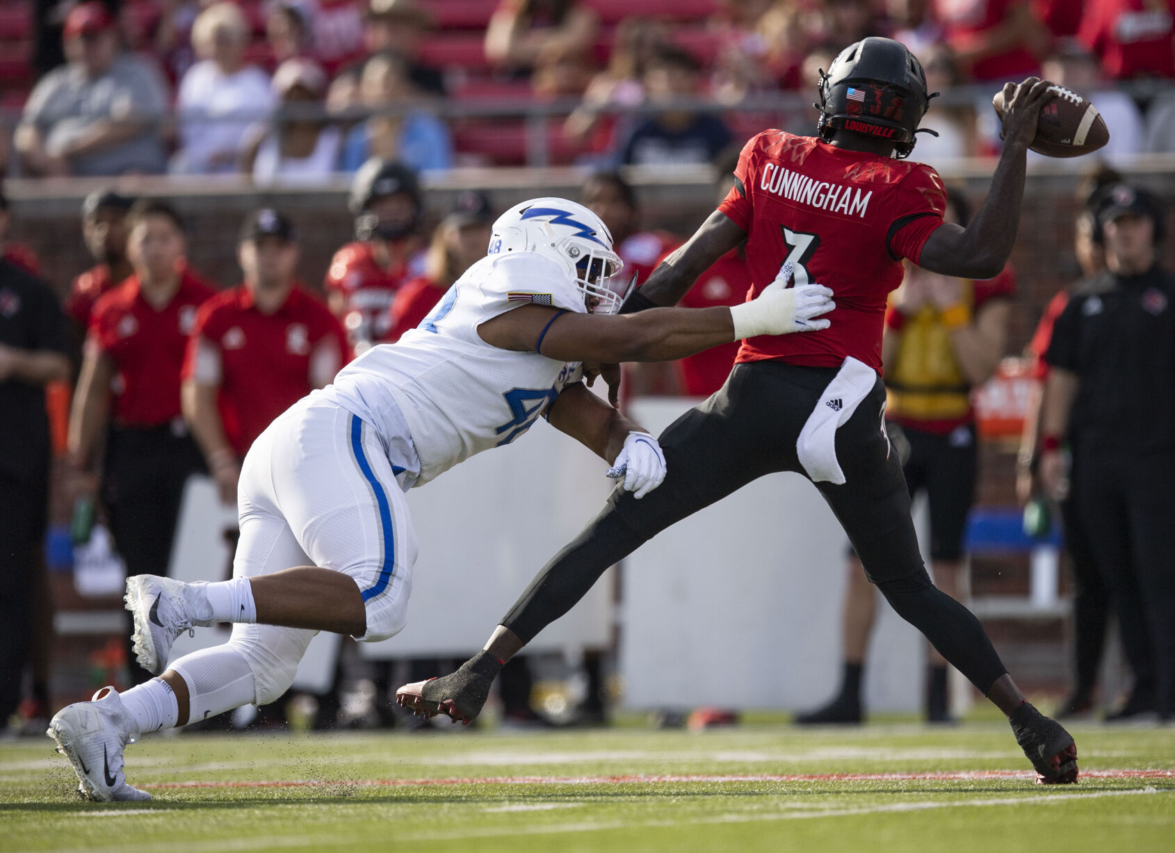 Air Force sophomore Jayden Thiergood (48) goes in for the tackle of Louisville junior quarterback Malik Cunningham (3) as the Air Force Falcons take on the Louisville Cardinals during the 2021 First Responder Bowl at Gerald J. Ford Stadium on the campus of Southern Methodist University in Dallas, Texas on Tuesday, Dec. 28, 2021. The Falcons defeated the Cardinals and won the bowl game by a score of 31-28. (Chancey Bush/ The Gazette) (Chancey Bush/ The Gazette)