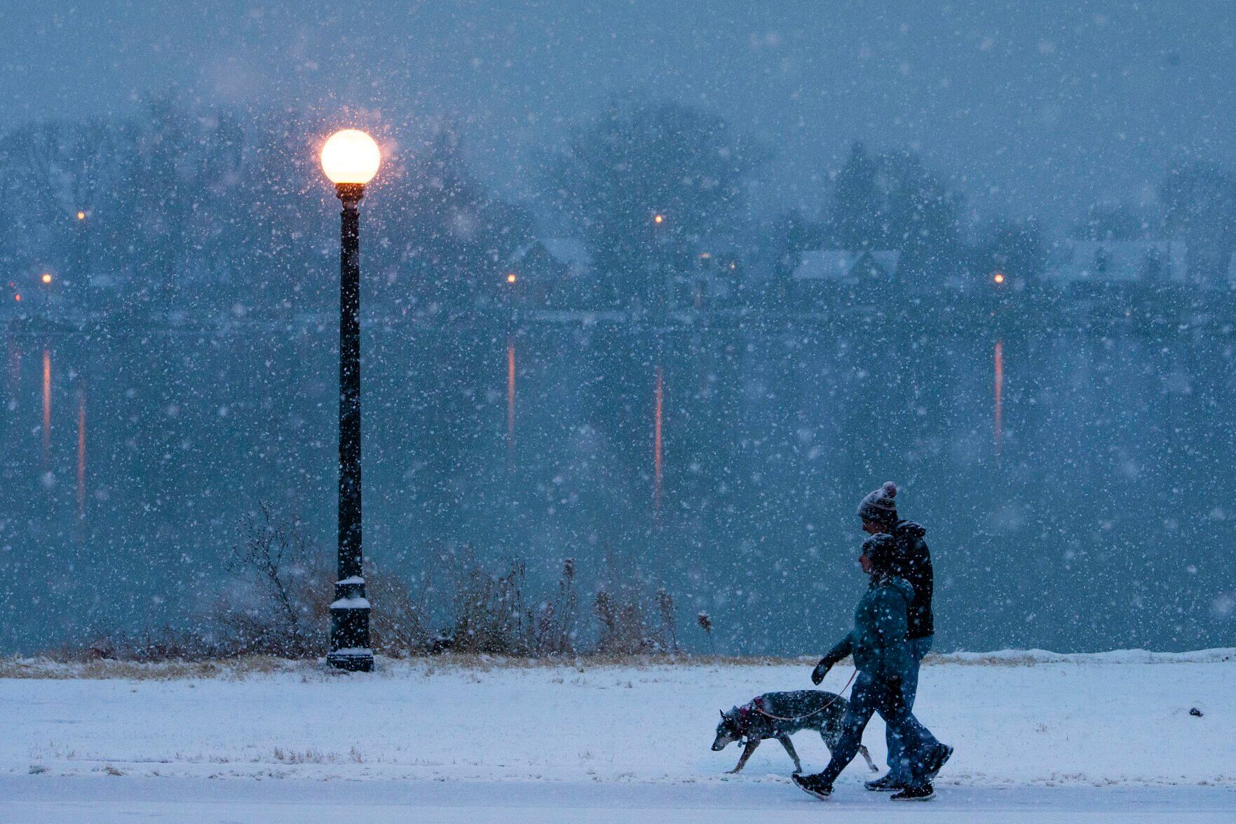 Rebecca Walker and Pete Schmidt walk 15-year-old blue heeler Rocket around Smith Lake during morning snowfall on Friday, Dec. 10, 2021, at Washington Park in Denver, Colo. (Timothy Hurst/The Gazette) (TimHursttim.hurst@gazette.comhttps://secure.gravatar.com/avatar/aca82bd62b4ee425c598527cd6faa1b1?d=mm&r=g)