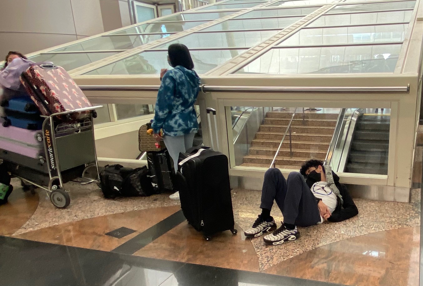 As cancellations and delays continued at Denver International Airport Monday, travelers were splayed out where ever they could find an empty spot. (Carol McKinley)
