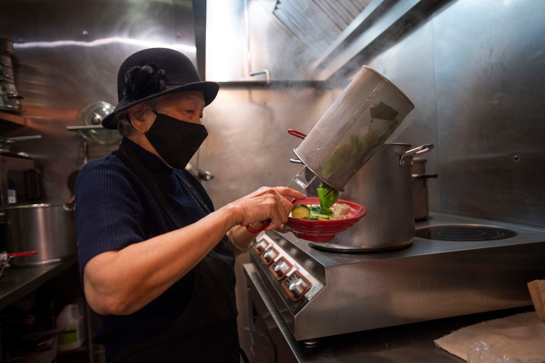 Anna Zoe, known as Ma Ma, 78, makes her special cuisine at her restaurant Zoe Ma Ma in Boulder in October. (Chancey Bush, The Gazette)