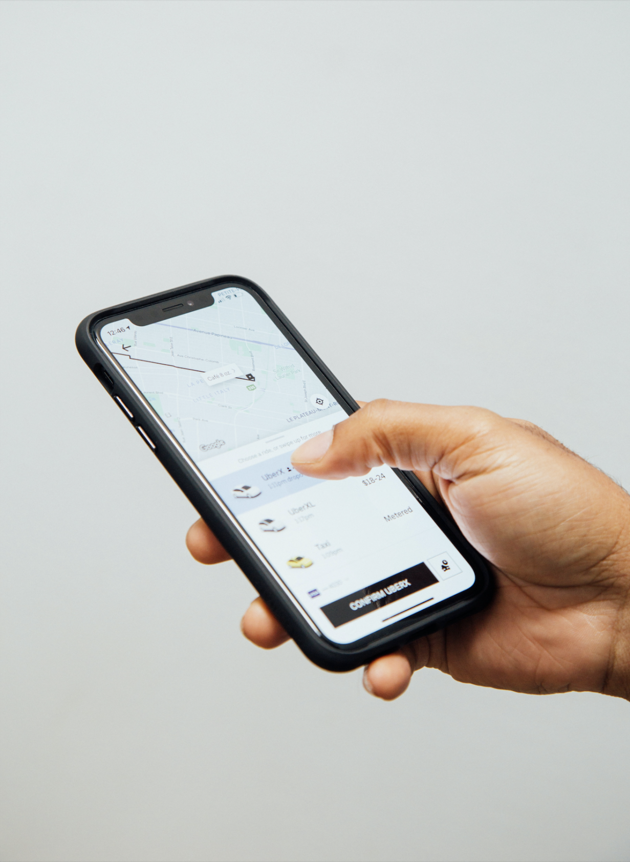 uber ride share app cell phone iphone (Charles Deluvio/ Unsplash)