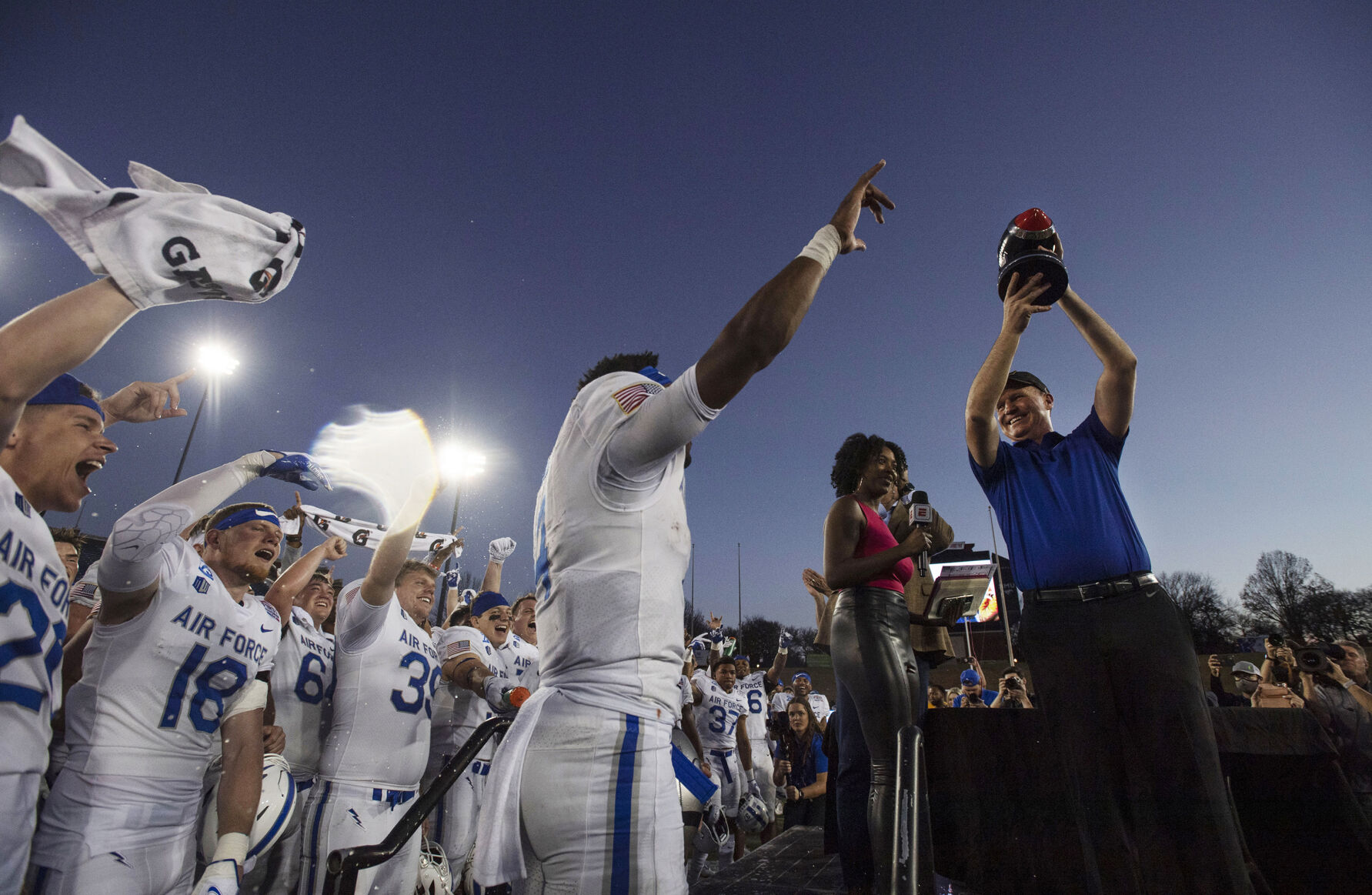 Air Force head coach Troy Calhoun celebrates with the team as he holds up their trophy after the Air Force Falcons defeat the Louisville Cardinals during the 2021 First Responder Bowl at Gerald J. Ford Stadium on the campus of Southern Methodist University in Dallas, Texas on Tuesday, Dec. 28, 2021. The Falcons defeated the Cardinals and won the bowl game by a score of 31-28. (Chancey Bush/ The Gazette) (Chancey Bush/ The Gazette)