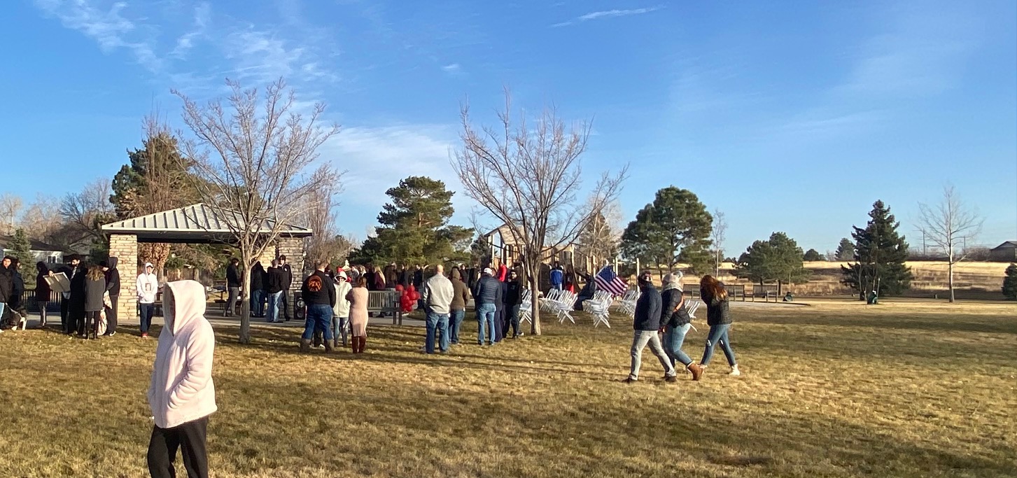 Friends and family of Peyton Blitstein bundle up as they gather for his memorial at Aurora's Triangle Park. (Carol McKInley)