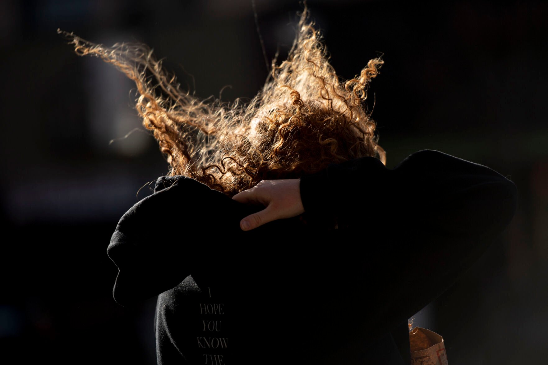 Sara Sendelbach braces as strong wind gusts blow dust and debris in downtown Colorado Springs during a wind storm that swept through El Paso County on Wednesday, Dec. 15, 2021. (Chancey Bush/ The Gazette) (Chancey Bush/ The Gazette)