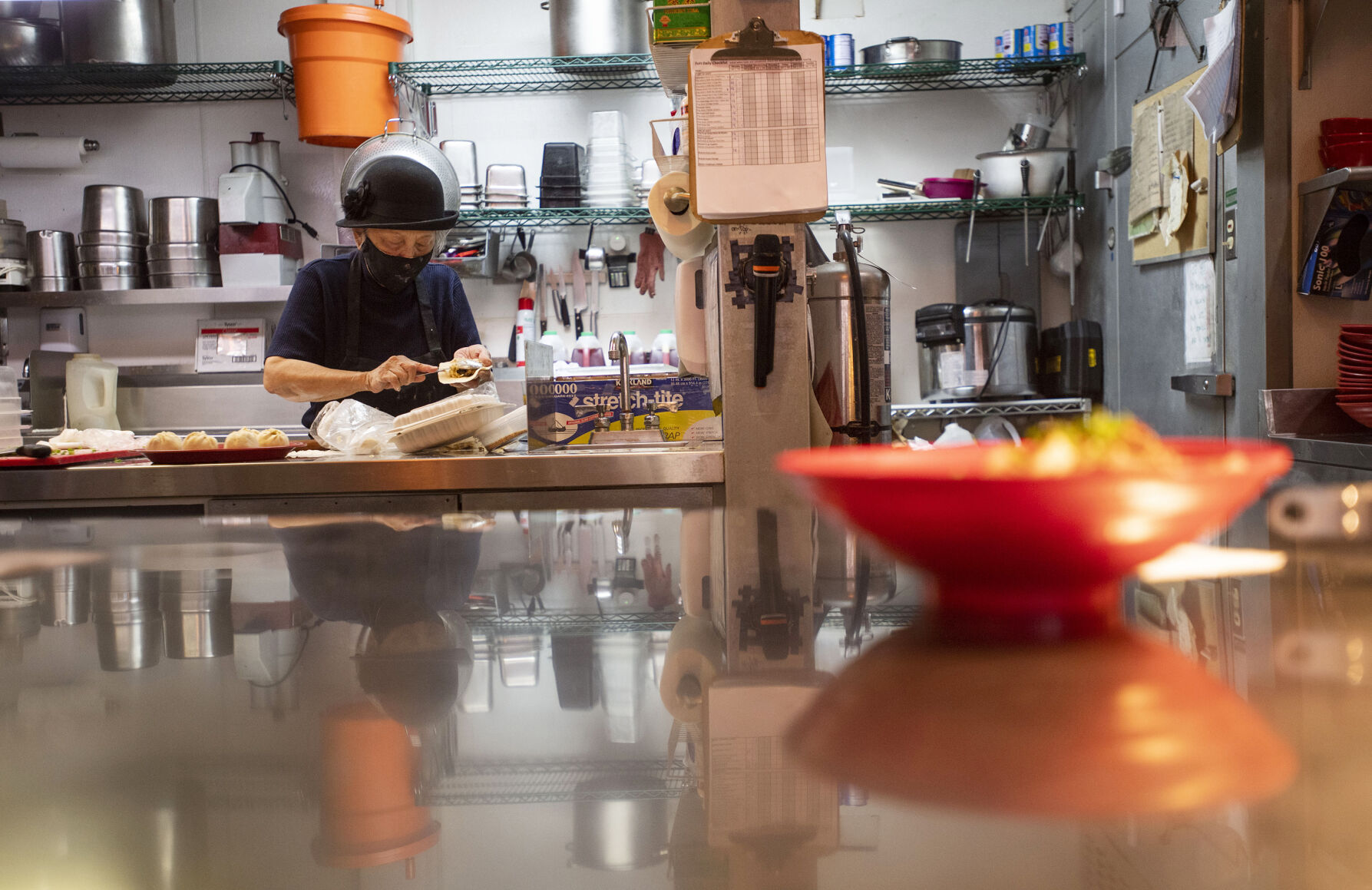 Anna Zoe, known as Ma Ma, prepares bao, fluffy, hand-rolled dough buns that are steamed, pan-fried and stuffed with spice and veggies and savory, saucy pork, at her restaurant, Zoe Ma Ma, in Boulder. TV’s Guy Fieri is among the restaurant’s fans. (Photos by Chancey Bush, The Gazette)