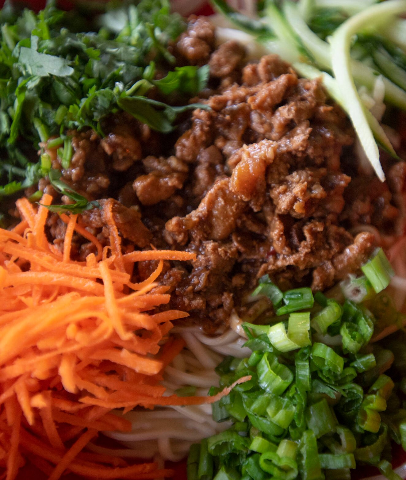 Za Jiang Mian dish, described as a classic northern Chinese noodle dish with fresh organic egg noodle topped with savory ground pork sauce and julienne vegetables at Zoe Ma Ma in Boulder. (Chancey Bush, The Gazette)