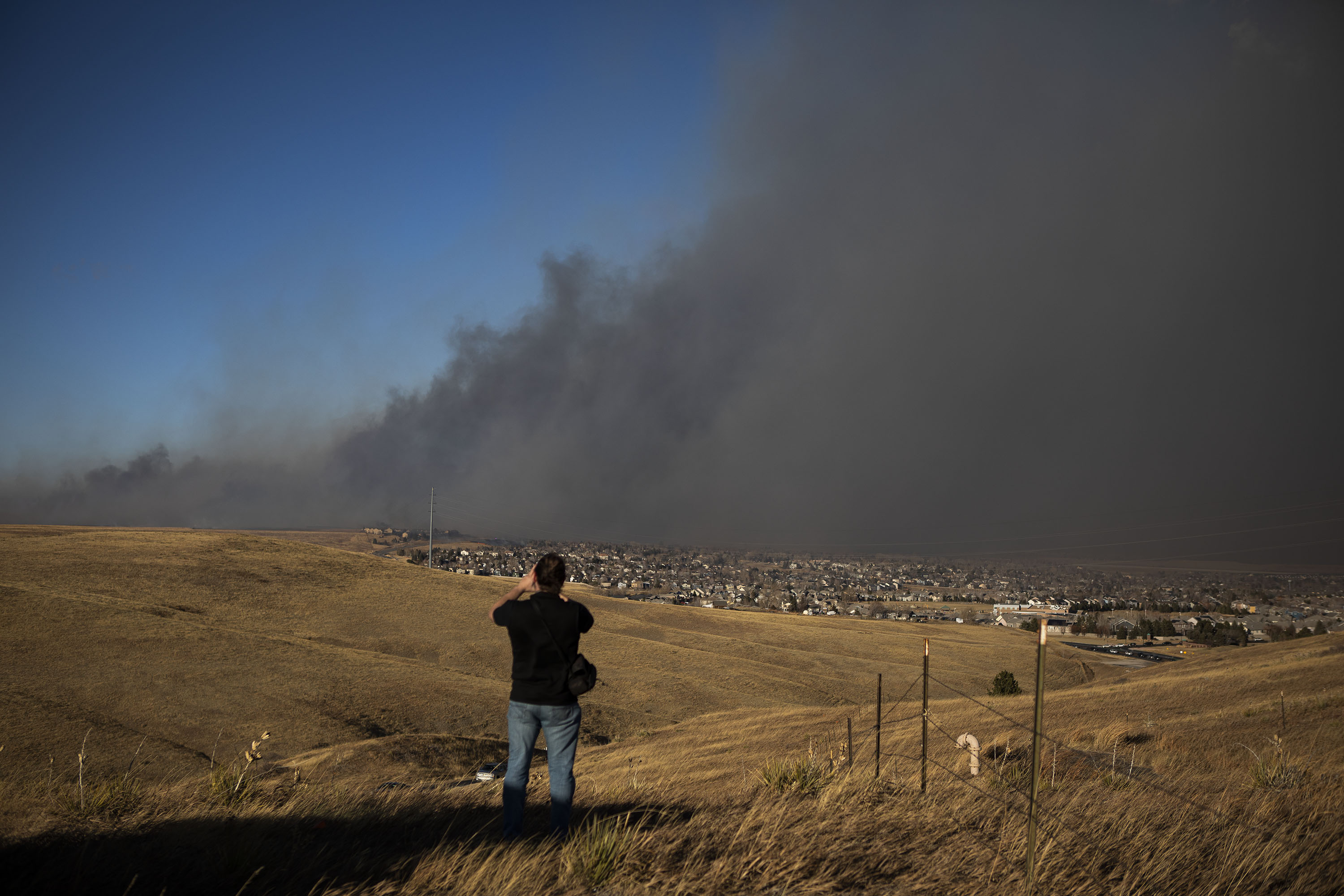 David Miller looks on as a grassfire moves toward a neighborhood in Superior, Colo., on Thursday, Dec. 30, 2021. (Timothy Hurst/The Gazette) (Timothy Hurst)