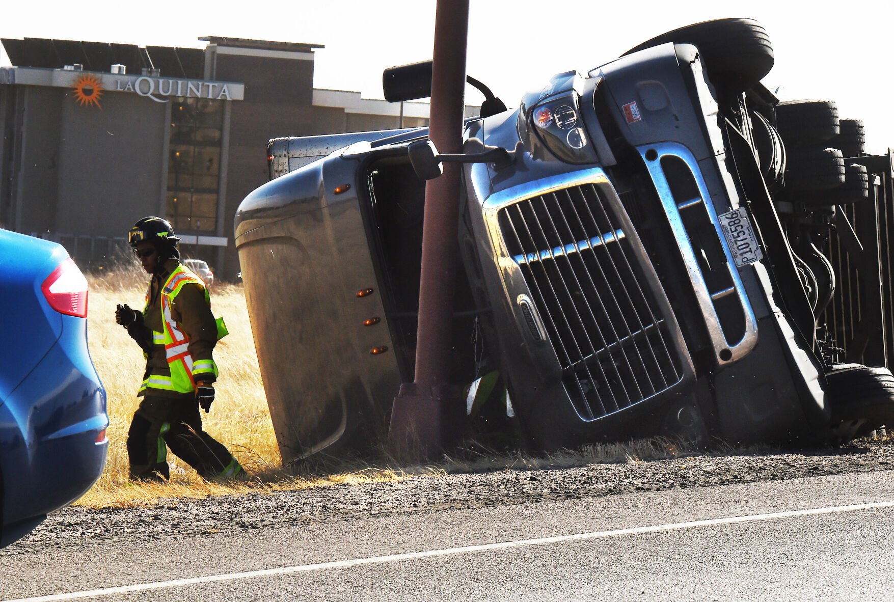 A semi-truck collided with a light pole on the onramp of I-25 north of N. Academy Blvd.. Over a dozen semi trucks were blown over by high winds in the Pikes Peak region on I-25. (Photo by Jerilee Bennett, The Gazette) (Jerilee Bennett)
