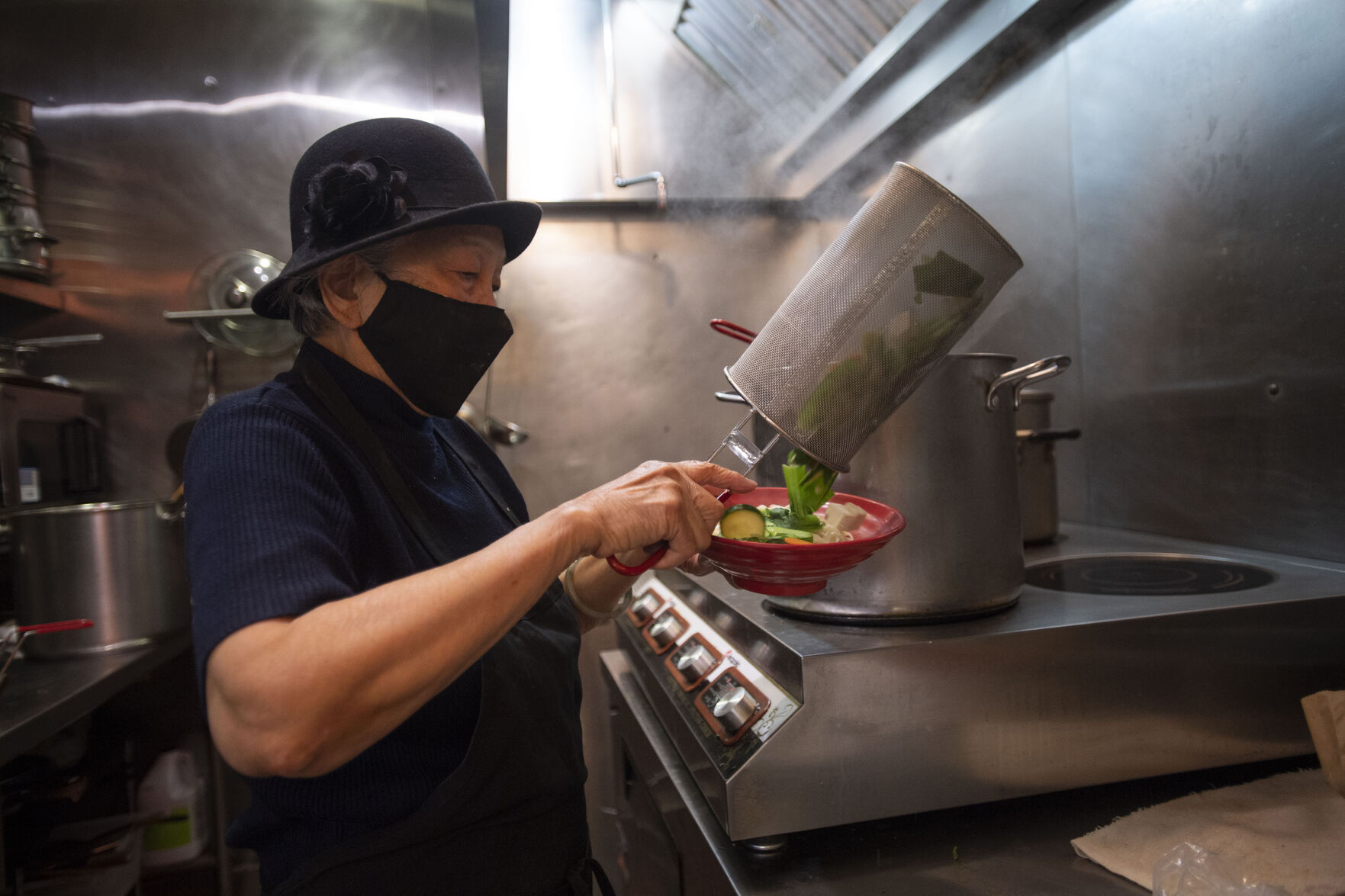 Anna Zoe, known as Ma Ma, 78, makes her special cuisine at her restaurant Zoe Ma Ma in Boulder in October. (Chancey Bush / The Gazette) (Chancey Bush/ The Gazette)
