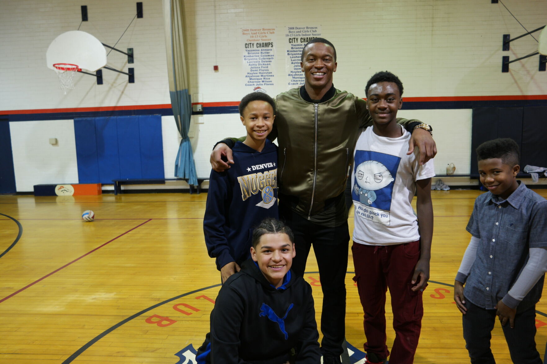 Former Broncos wide receiver Demaryius Thomas (middle) stands with Jayden Tolson (right) and other kids at the Denver Broncos Boys & Girls Club. (Photo provided by Denver Broncos)