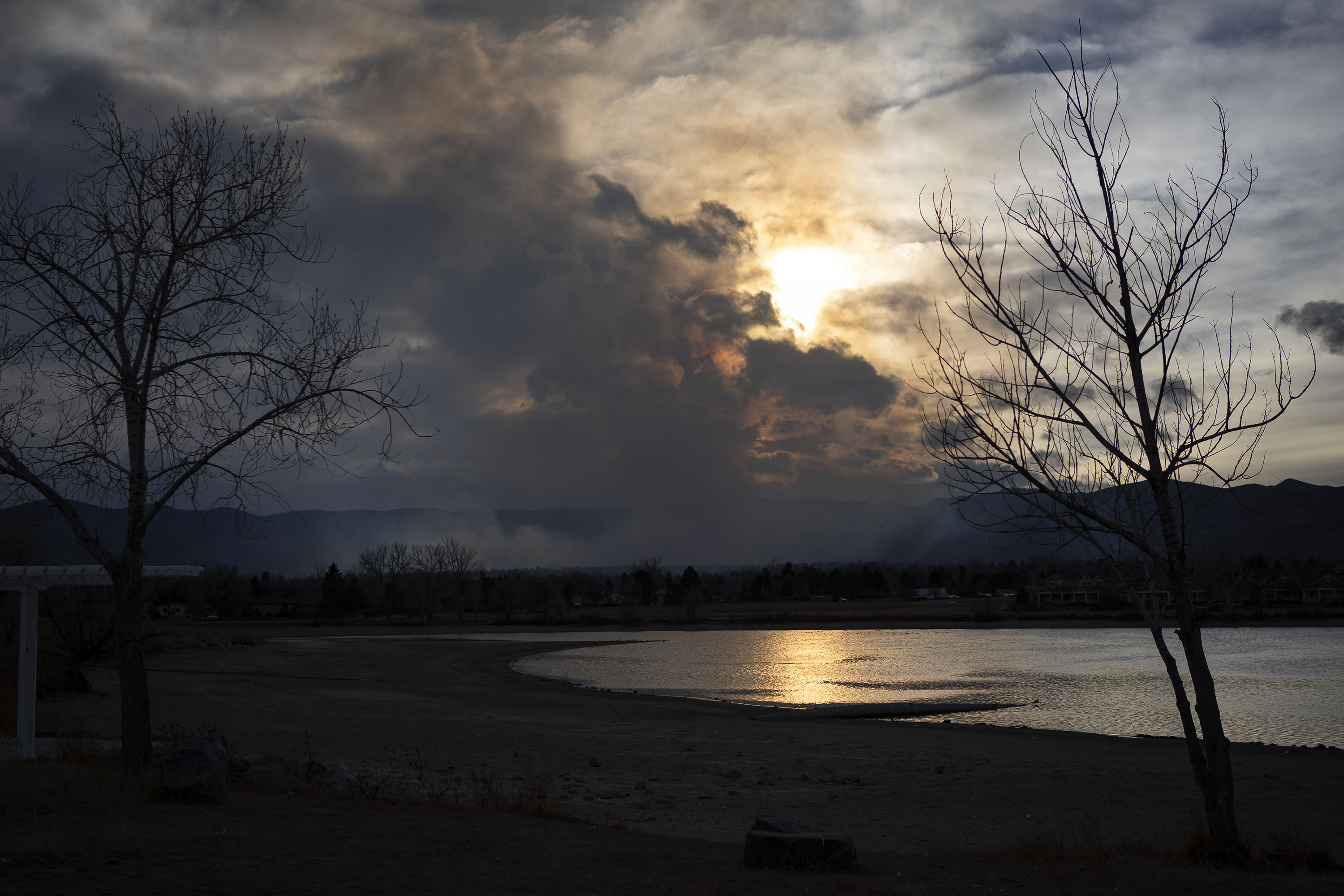 A plume fo smoke rising from a grassfire southwest of the Denver Metro area can be seen from Johnson Reservoir on Monday, Dec. 27, 2021, in Littleton, Colo. (Timothy Hurst/The Gazette) (Timothy Hurst)