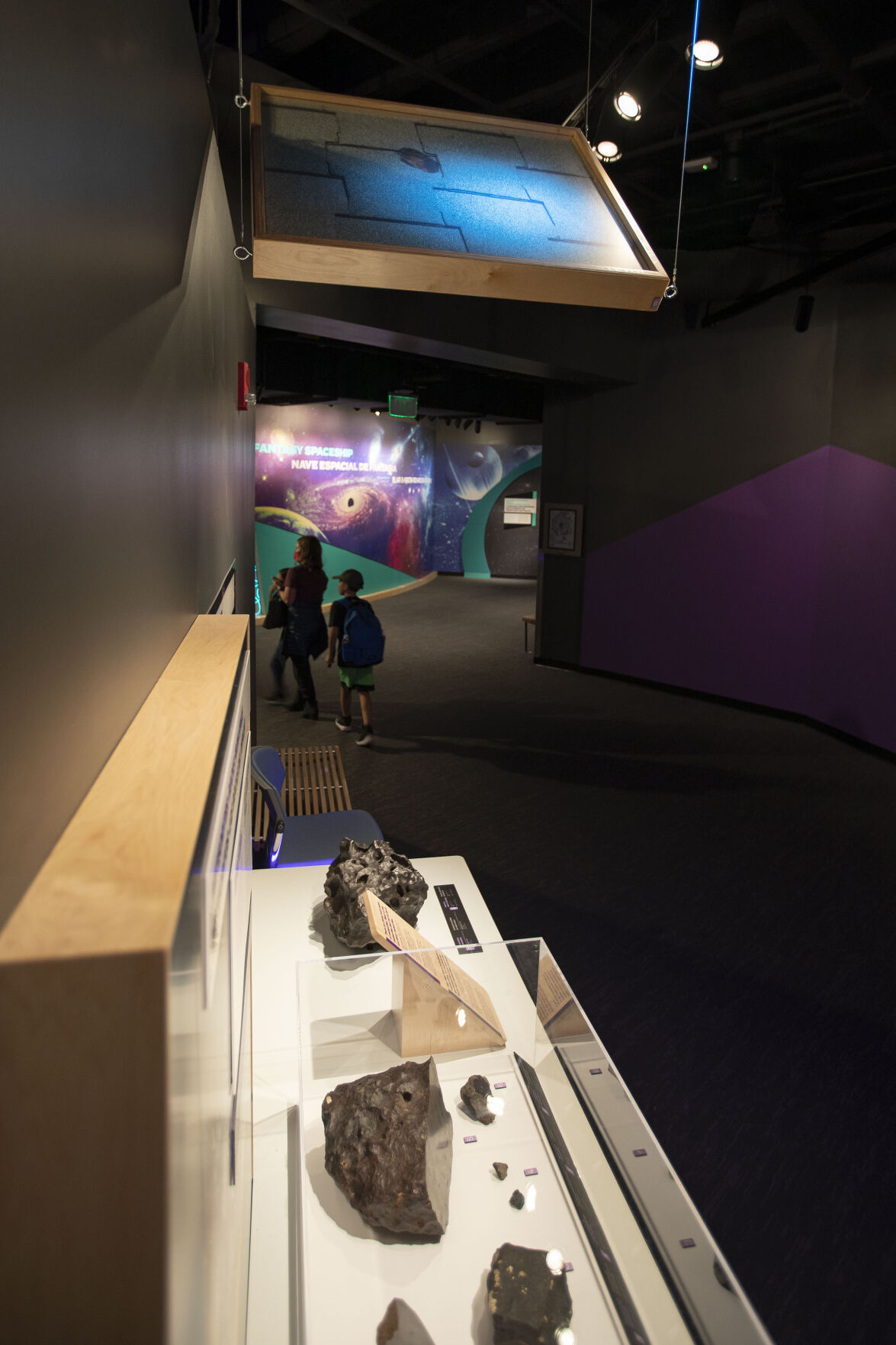 A section of a roof pierced by a meteorite near Cañon City in 1973 hangs from the ceiling above the meteorite and others at the Denver Museum of Nature and Science on Monday, Dec. 13, 2021, in Denver, Colo. (Timothy Hurst/The Gazette) (Timothy Hurst)