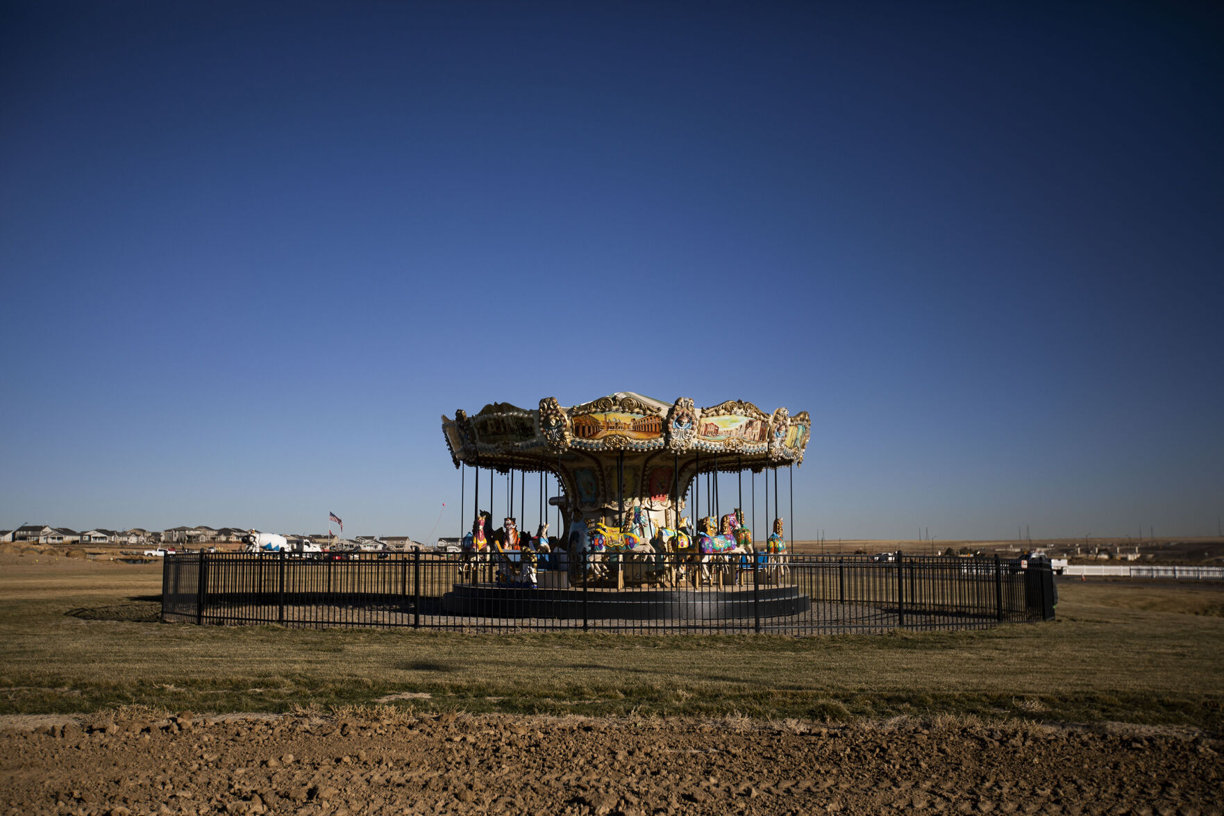 A carousel sits in an otherwise empty field that will someday be the event lawn of the Aurora Highlands Metro District, as seen Dec. 2 in Aurora. (Timothy Hurst, The DENVER Gazette)