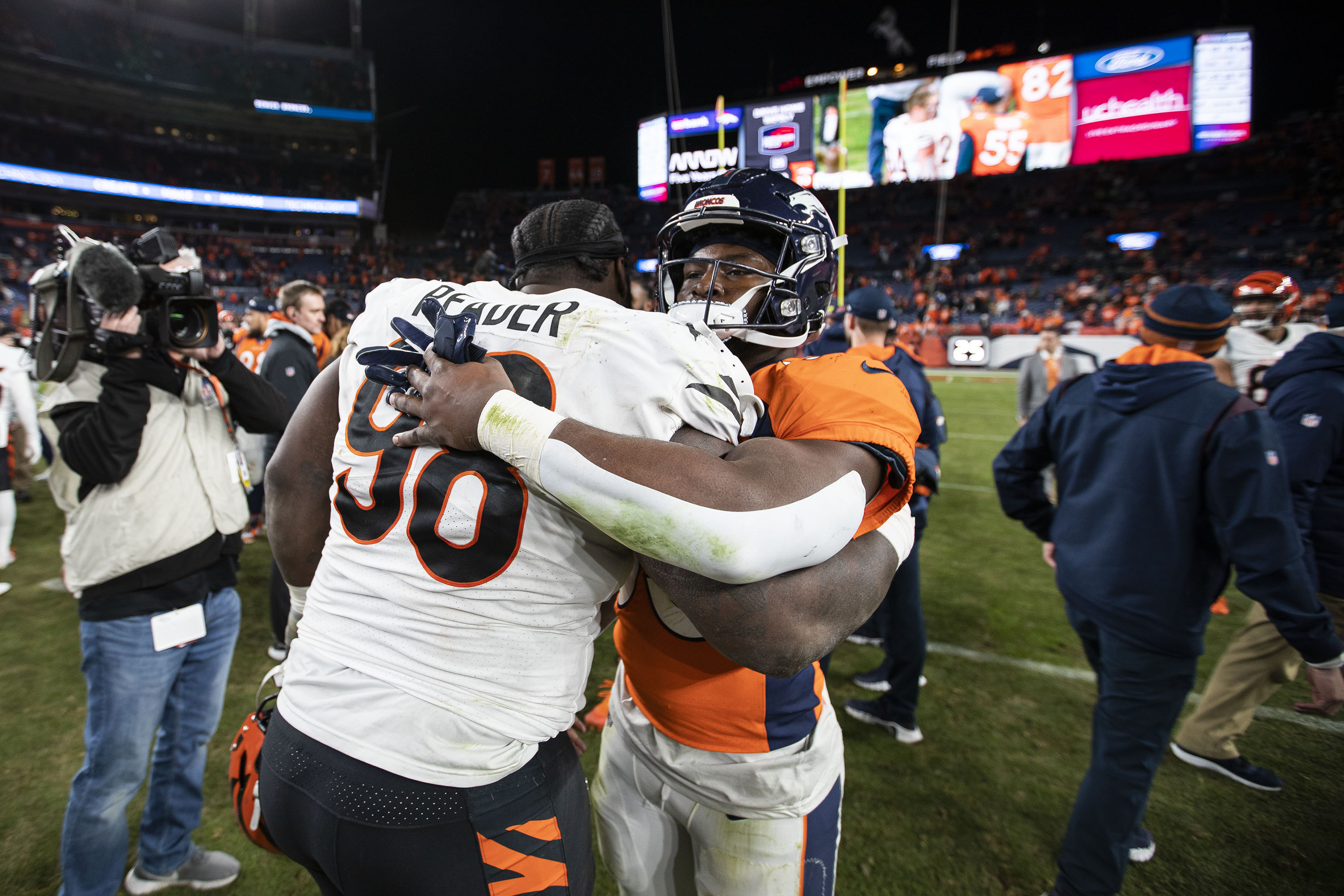 Denver Broncos running back Javonte Williams (33) and Cincinnati Bengals defensive tackle D.J. Reader (98) hug after a game on Sunday, Dec. 19, 2021, at Empower Field at Mile High in Denver, Colo. (Timothy Hurst/The Gazette) (TimHursttim.hurst@gazette.comhttps://secure.gravatar.com/avatar/aca82bd62b4ee425c598527cd6faa1b1?d=mm&r=g)