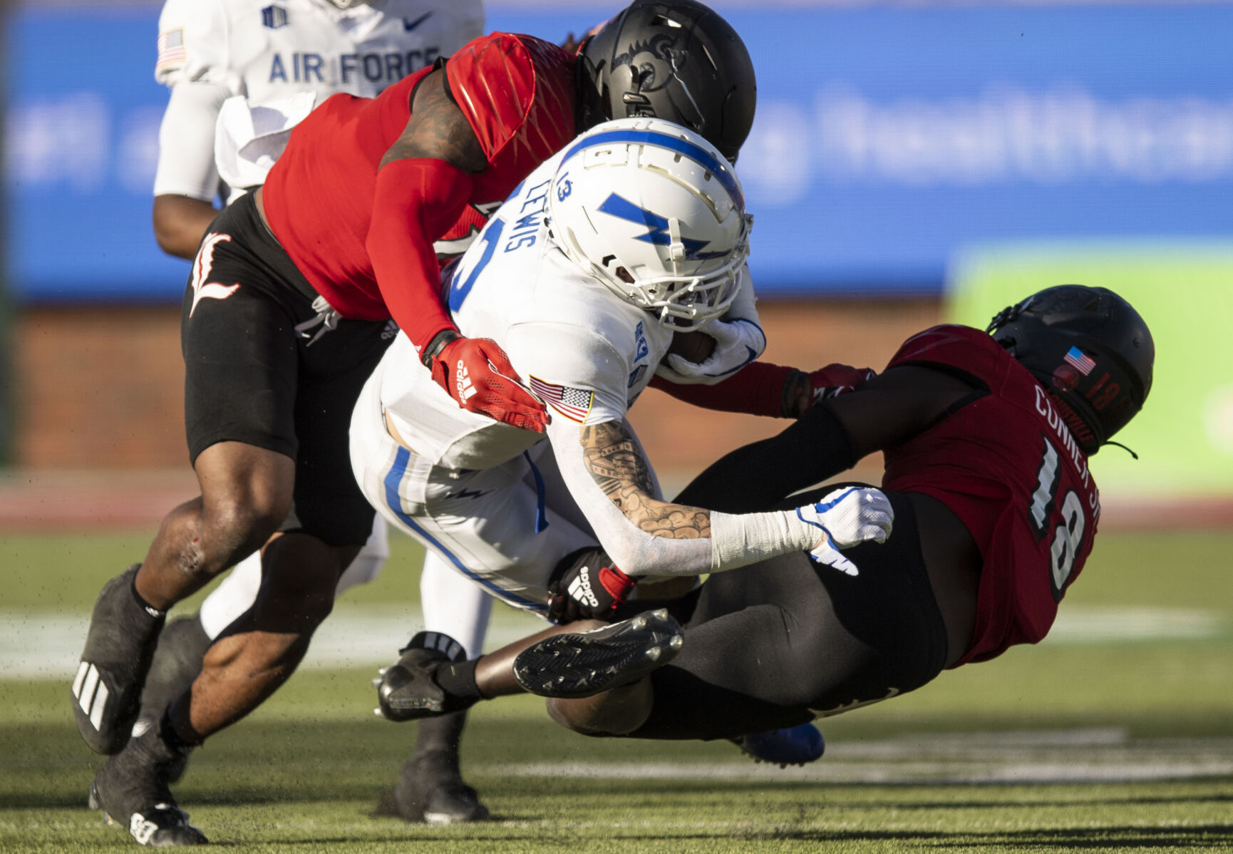 Air Force senior wide receiver Brandon Lewis (13) gets tackled as the Air Force take on the Louisville Cardinals during the 2021 First Responder Bowl at Gerald J. Ford Stadium on the campus of Southern Methodist University in Dallas, Texas on Tuesday, Dec. 28, 2021. The Falcons defeated the Cardinals and won the bowl game by a score of 31-28. (Chancey Bush/ The Gazette) (Chancey Bush/ The Gazette)